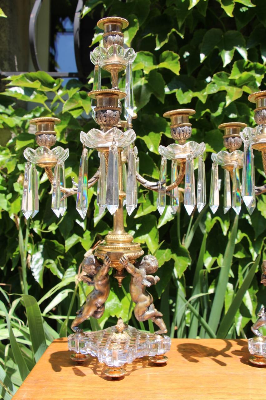 pair of candelabras in cut crystal, gilt and silver bronzesigned by the house of Baccarat in good condition wear from use to the gilding and silvering due to cleaning 