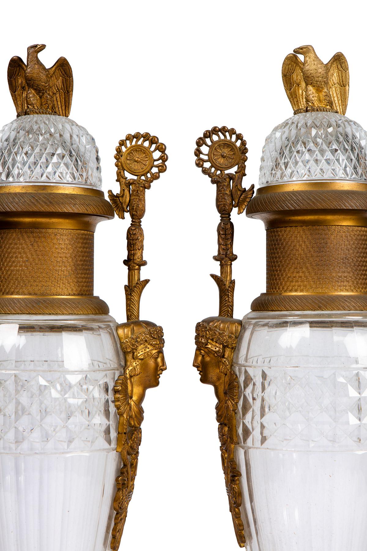 Pair of french empire style late 19 century crystal cut ormolu bronze original gilting
 You have eagle that embeds the base at the 4 corner, on the side of the vase you have magnificent women,s heads bronze surmonted by handles , the lids on the