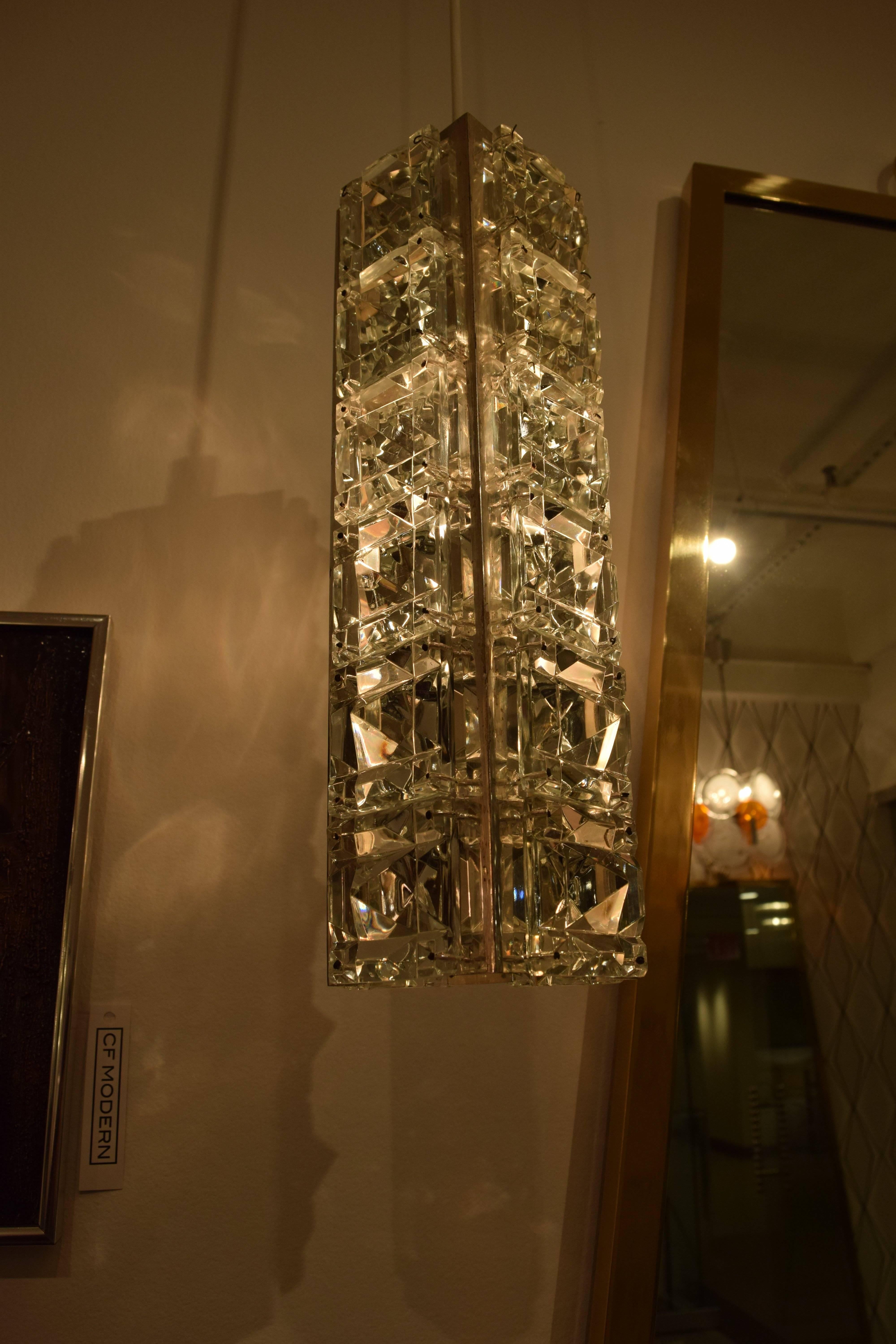 Pair of jeweled Austrian pendant lights with faceted crystal in silver plated frames. Each pendant takes a single 60w bulb. Silver has some patina due to age. Wired and ready to use.