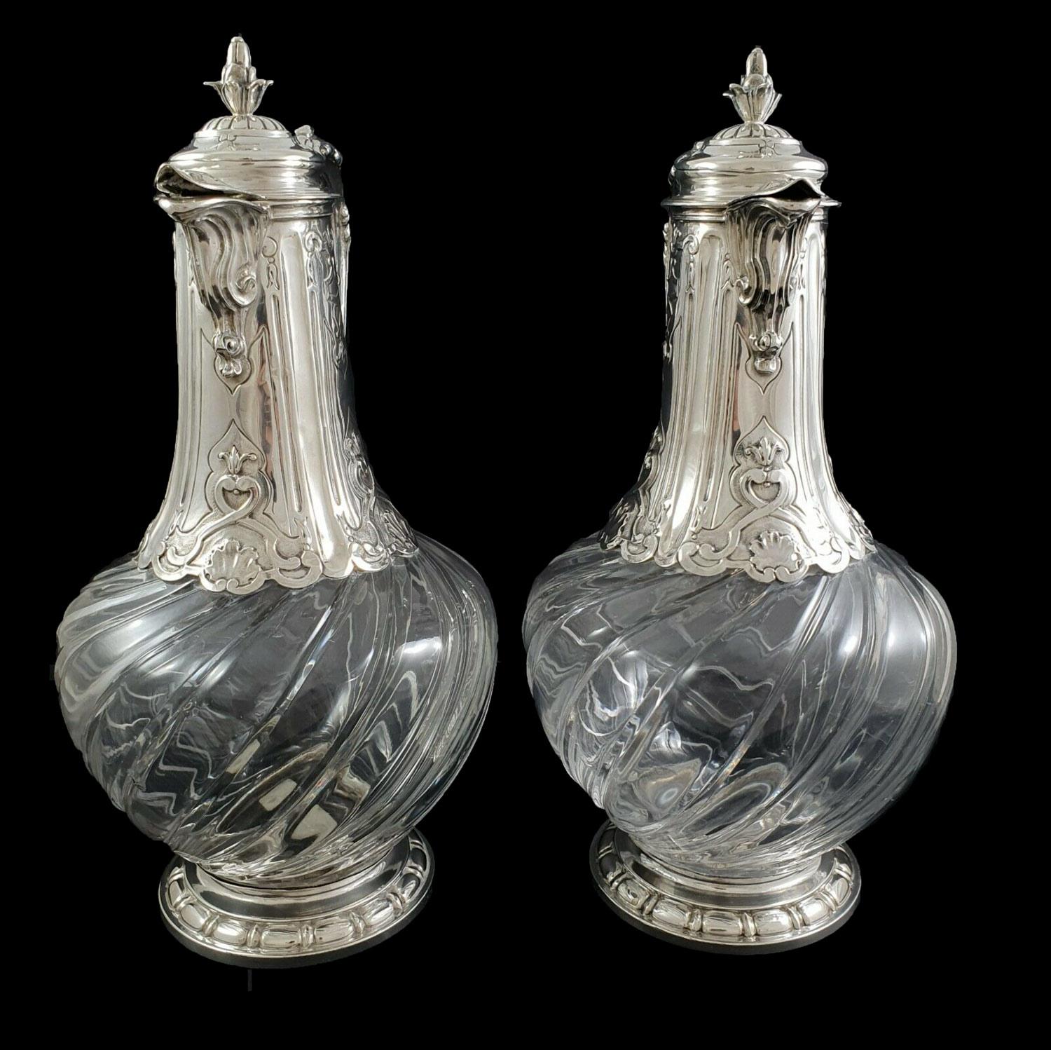 Pair of 19th-century typical french twisted and hand-engraved crystal ewers with sterling silver mount. Handle decorated with a dolphin head and acanthus leaves, high-part of the mount nicely chiseled and lid topped by a grenade knob. French silver