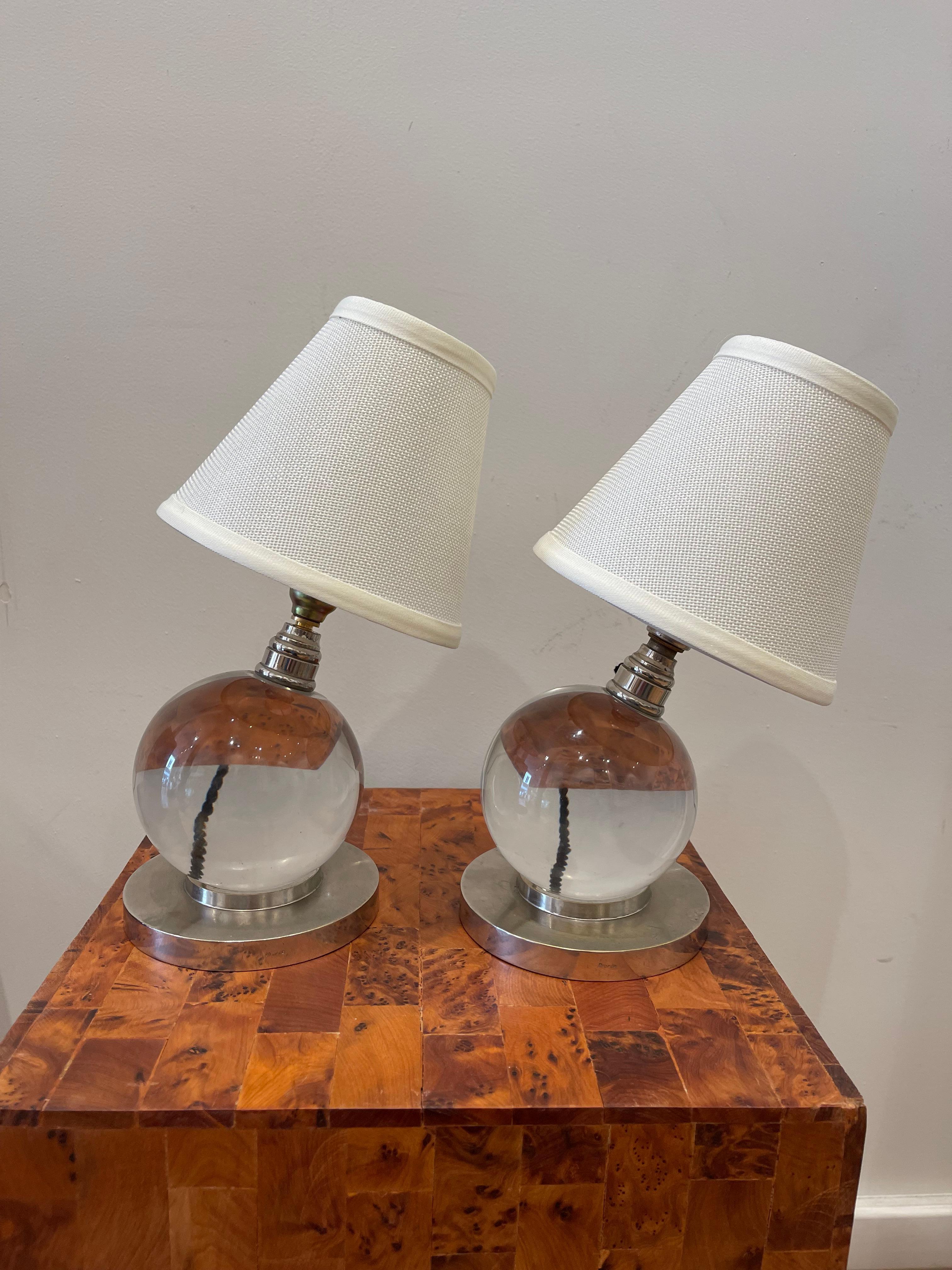   Iconic pair of modernist table lamps shaped as crystal ball resting on circular bases in silver bronze and stamped «bronze».
  Rare pair of lights by Jacques ADNET for the house BACCARAT known as well as model 