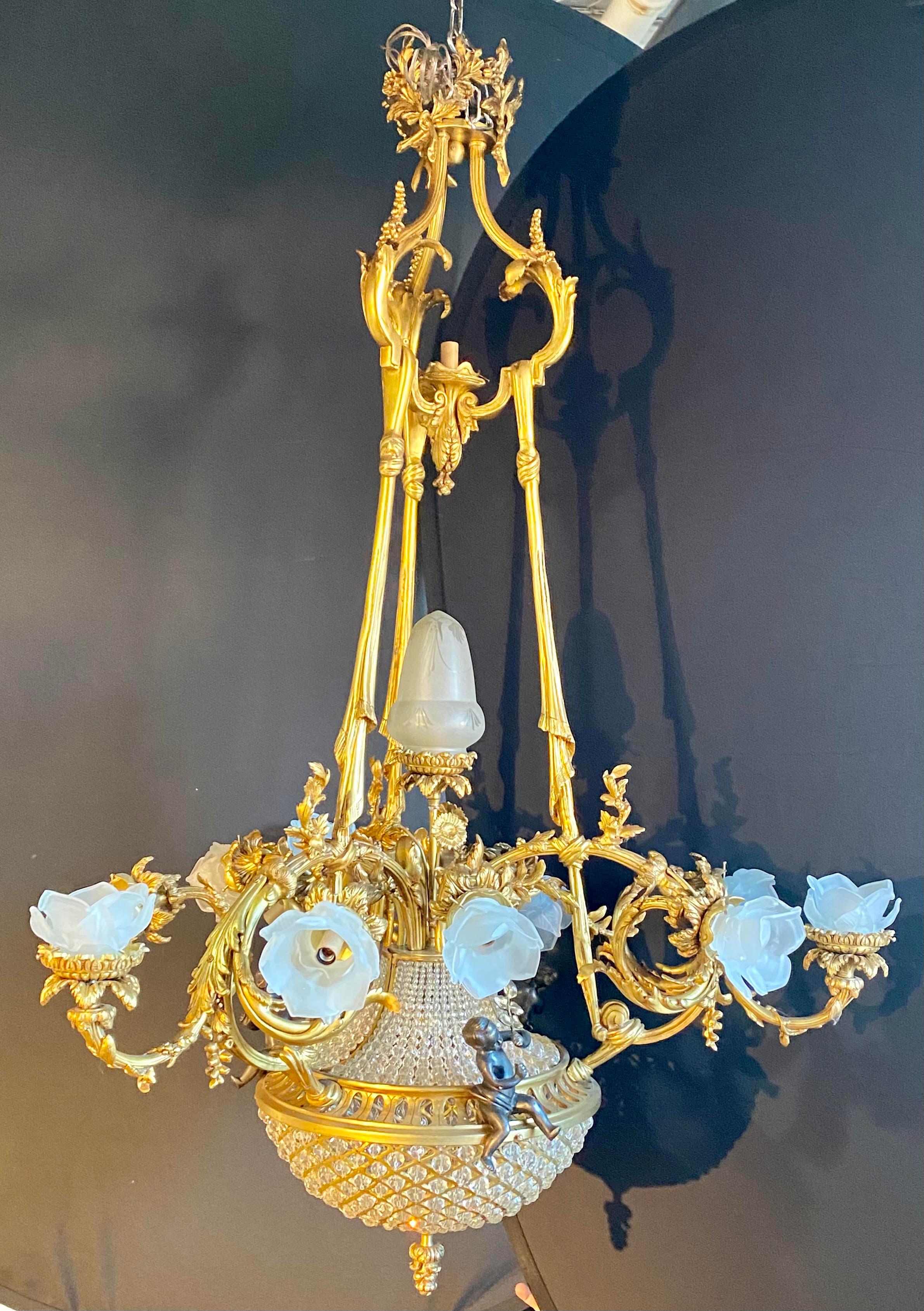 Pair of crystal beaded globe dore and patinated bronze cherub form 15-light. The cherubs measure 6.5 inches in height. These spectacular monumental chandeliers are simply stunning having the finest dore and cast would could possibly ask for. If