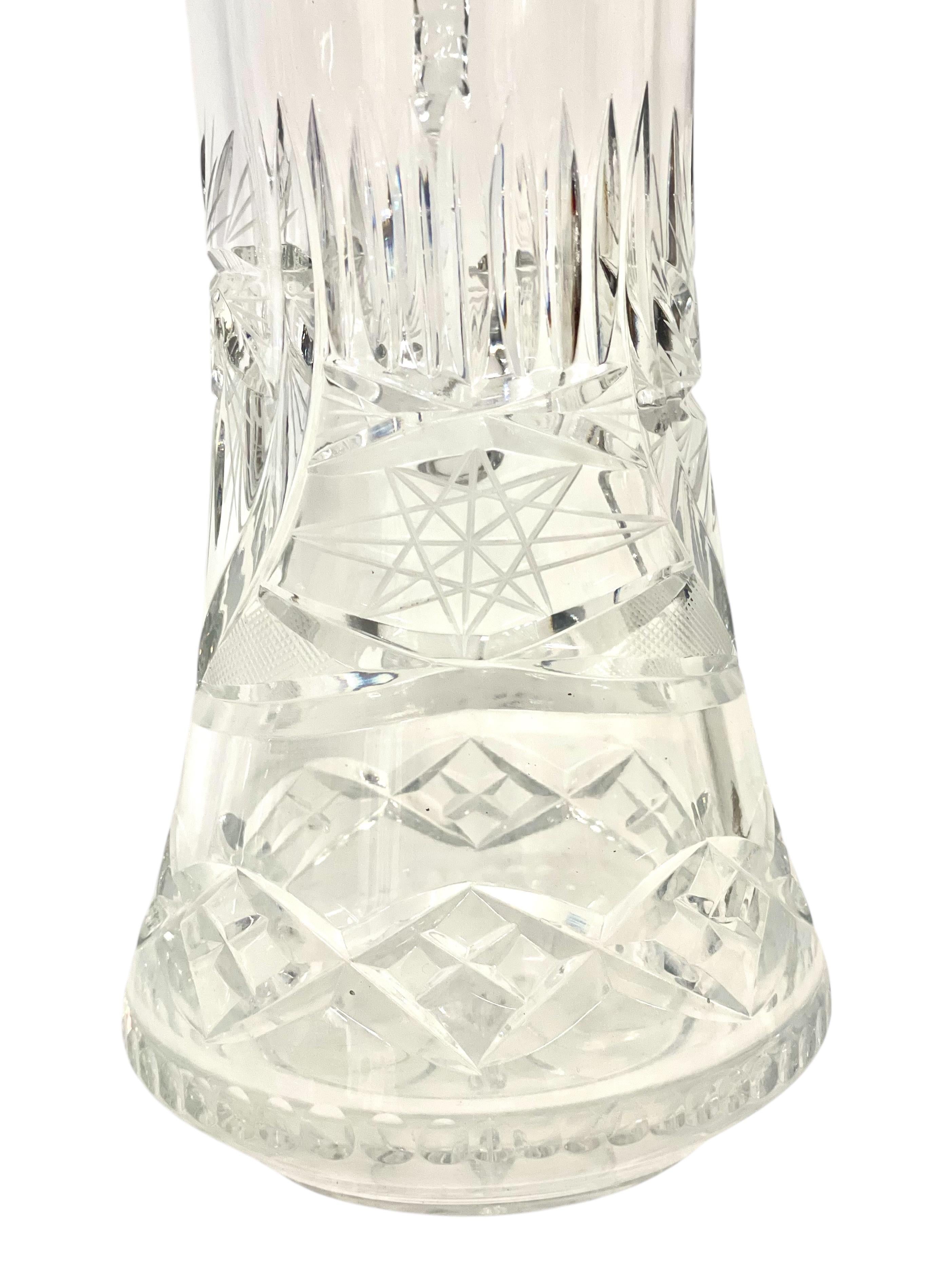 This stunning pair of French crystal carafes embodies the timeless elegance and sophistication associated with the style of Saint-Louis. Expertly crafted in the 20th century, these pieces feature intricate hand-cut starburst and diamond motifs,