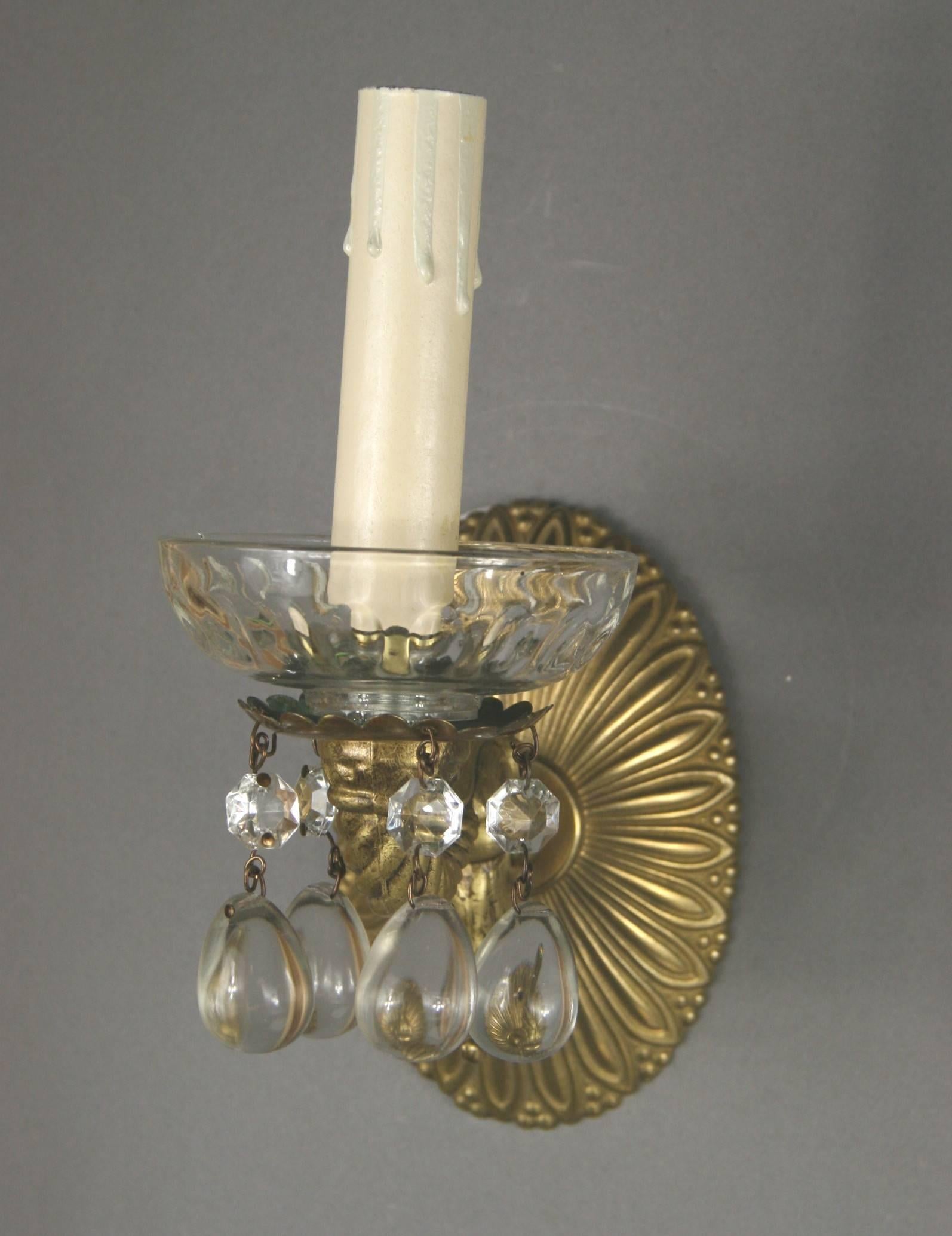 1-4066 pair of ornate brass single arm sconce ending with a glass bobeches, dressed with crystal drops.
Newly rewired. Takes 60 W candelabra base bulb.
Requires 2 