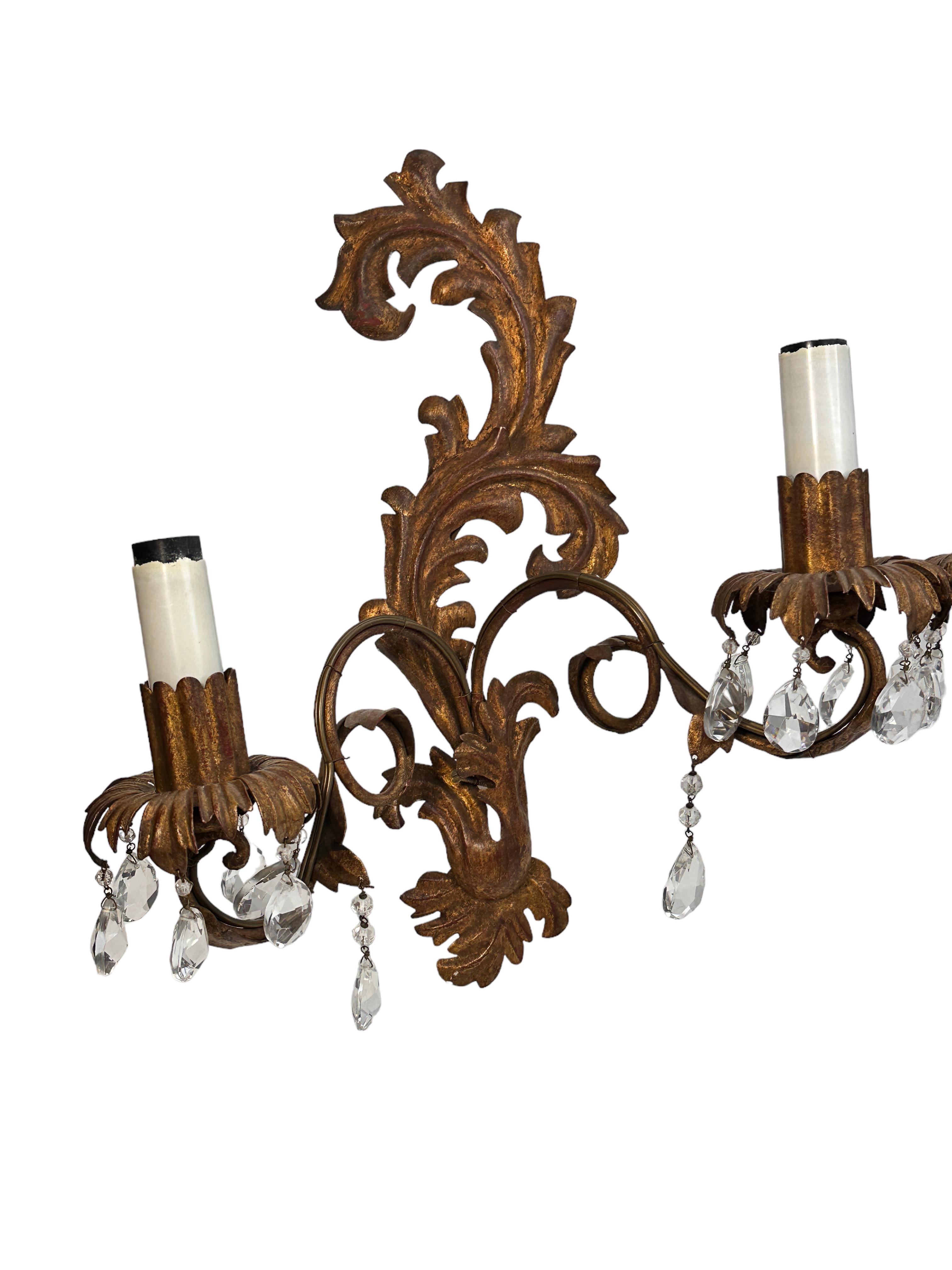 A pair metal gilded leaf sconces attributed to Banci Firenze with crystal stones. Each fixture requires two European E14 candelabra bulbs, each bulb up to 40 watts. The wall light has a beautiful patina and gives each room an eclectic statement.