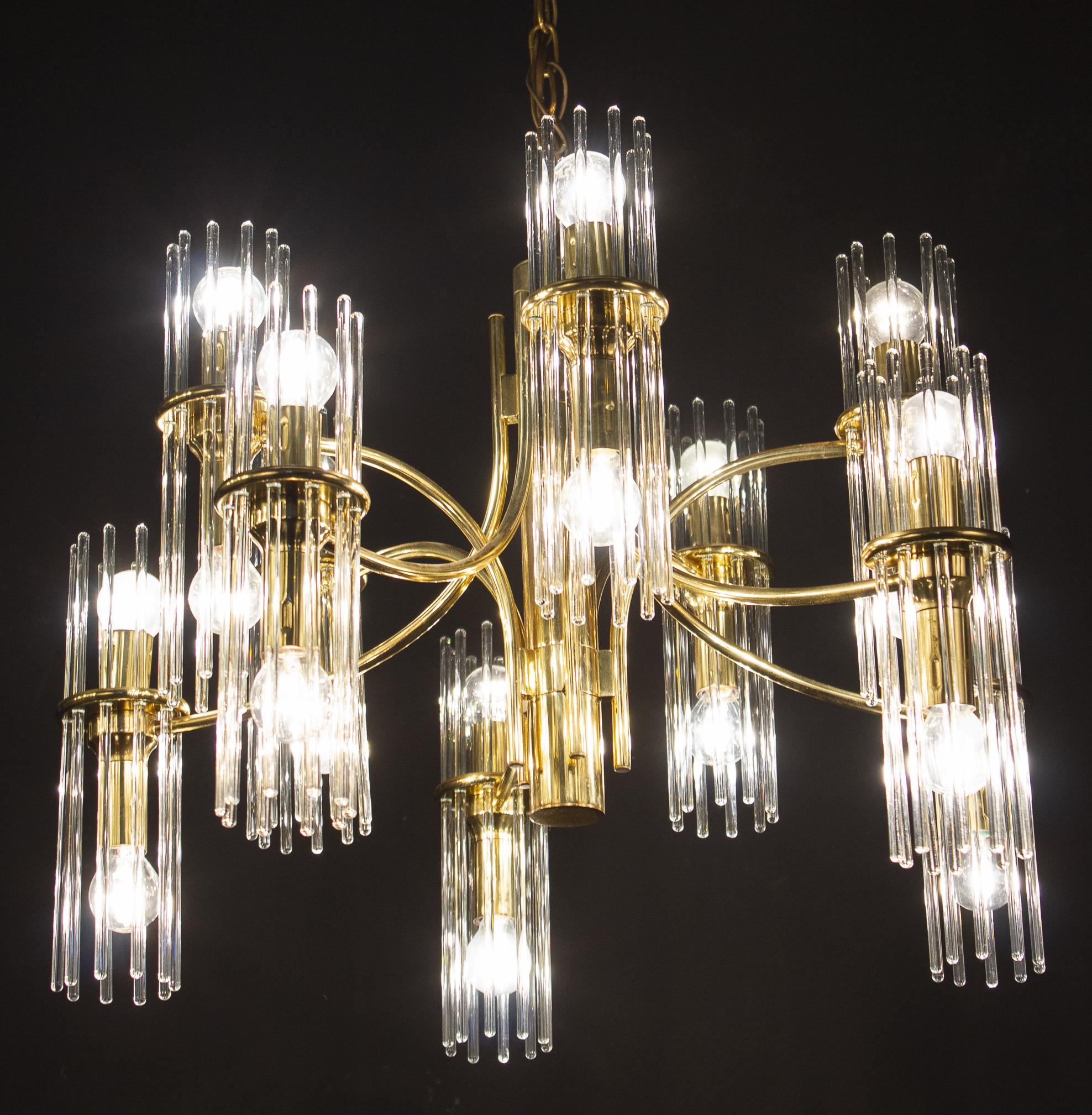 Pair of midcentury Gaetano Sciolari clears glass rod modernist chandeliers with brass frame.
Each with 20 E 14 light bulbs creates a fabulous light effect.

Excellent vintage condition.