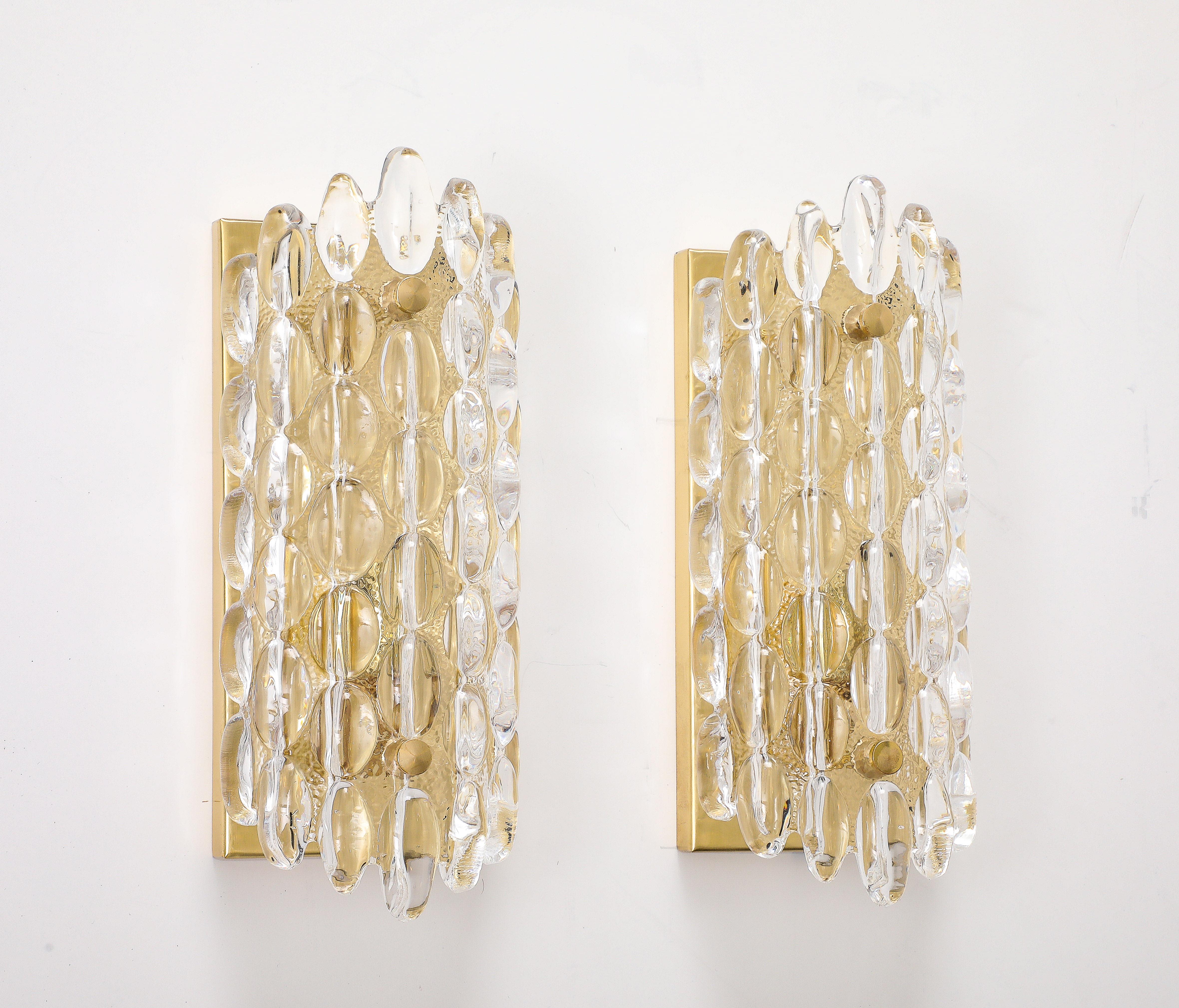 A wonderful pair of  1960's thick Crystal  bubble sconces.
The glass sits on a simple brass back plate with a single candelabra
light socket that has been newly rewired for the US.
60 Watts Maximum.
There are 4 Pairs Available. 