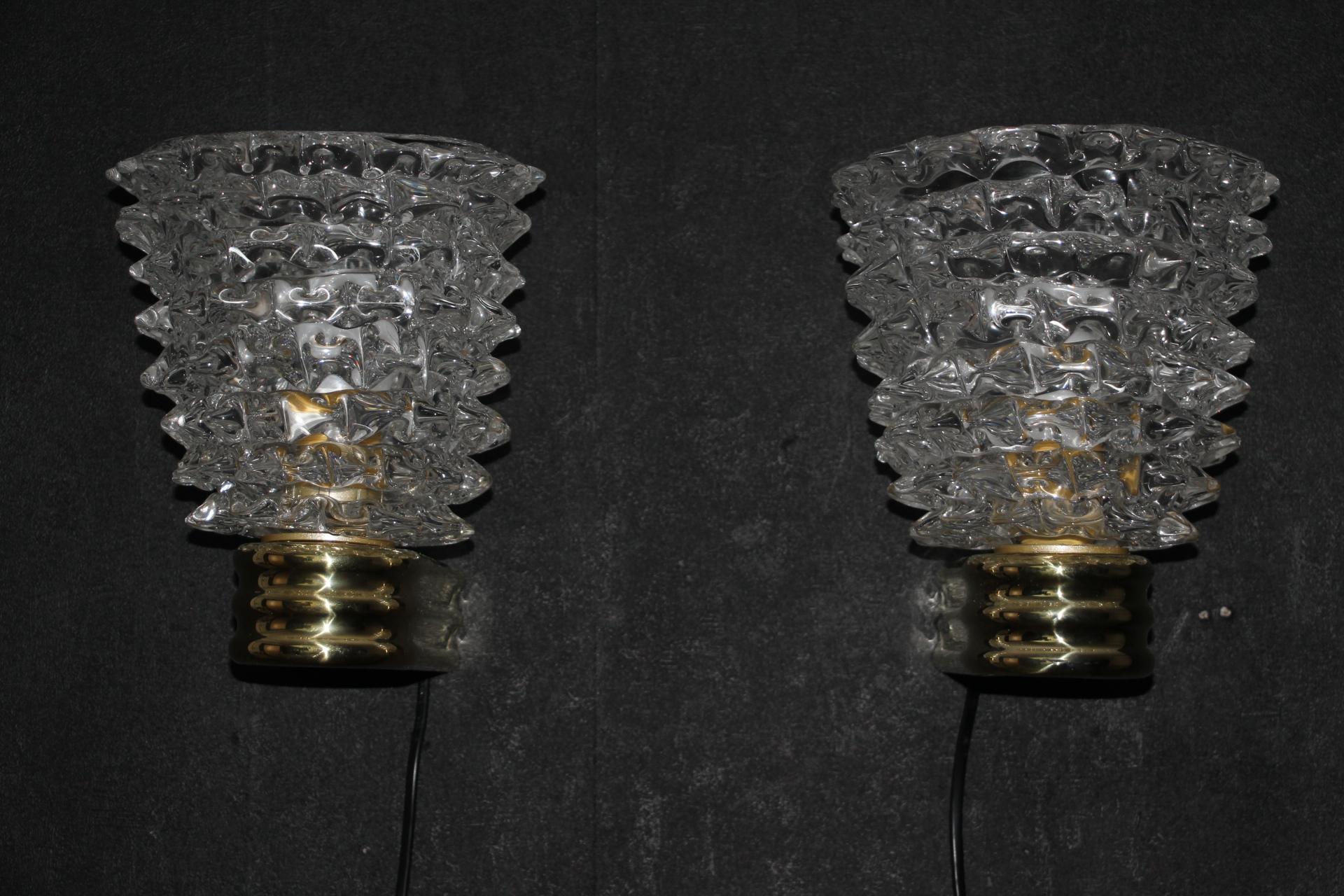 This magnificent pair of sconces from Murano was made according to the hand made rostrato glass technique . It means that each spike of glass was individually pulled in relief to get this fabulous 3 D look.
They stand on an elegant polished brass