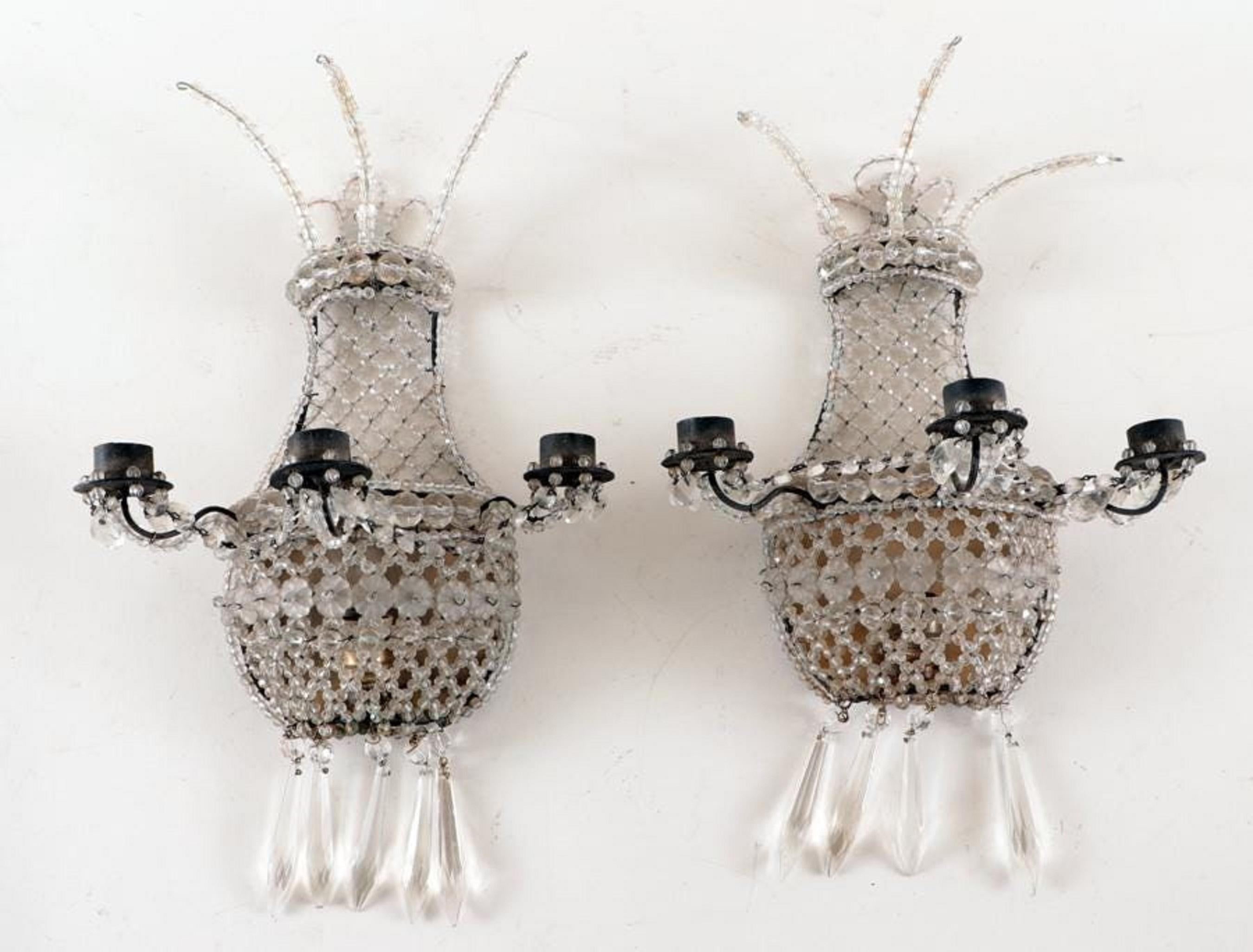 A pair of crystal wall sconces with interior electric light and 3 candle arms, circa 1920.