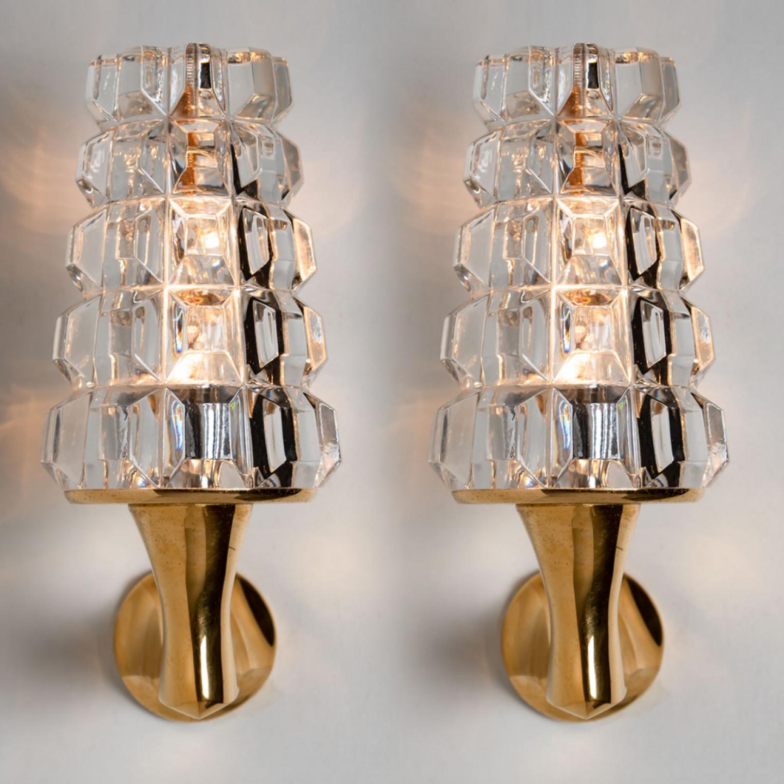 Pair of High end wall sconces, made in France, Europe, around 1970. The wall lights are made of cristall and a brass frame holding the glass.

Dimensions:
Height: 11.81 inch (30 cm)
Width: 3.94 inch (10 cm)
Depth: 7.48 inch (19 cm)

Please notice