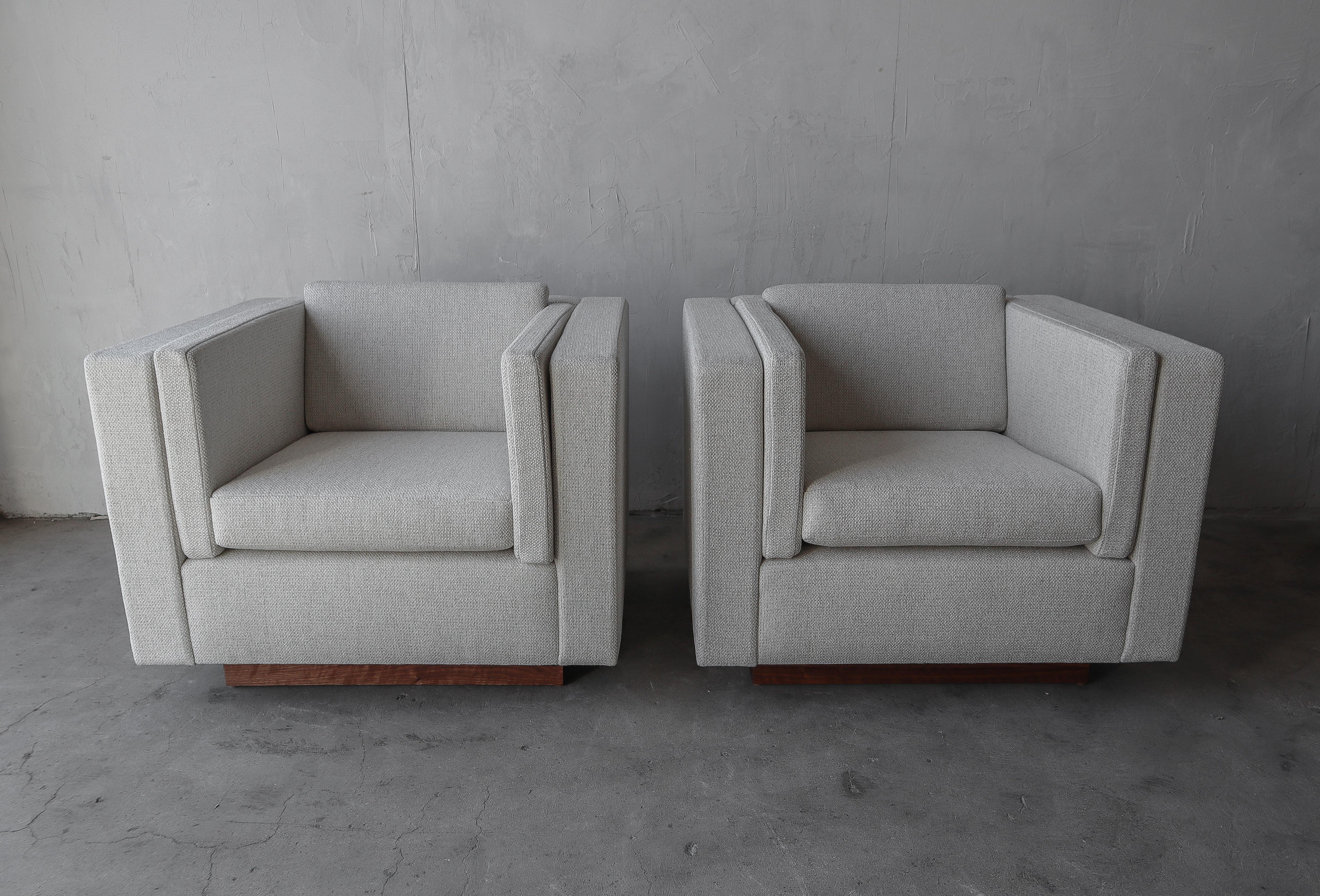 This is a gorgeous pair of cube lounge chairs with beautiful walnut plinth bases. The minimalistic style, clean lines a neutral upholstery make them the perfect addition to any decor.

The chairs have been professionally reupholstered in a great