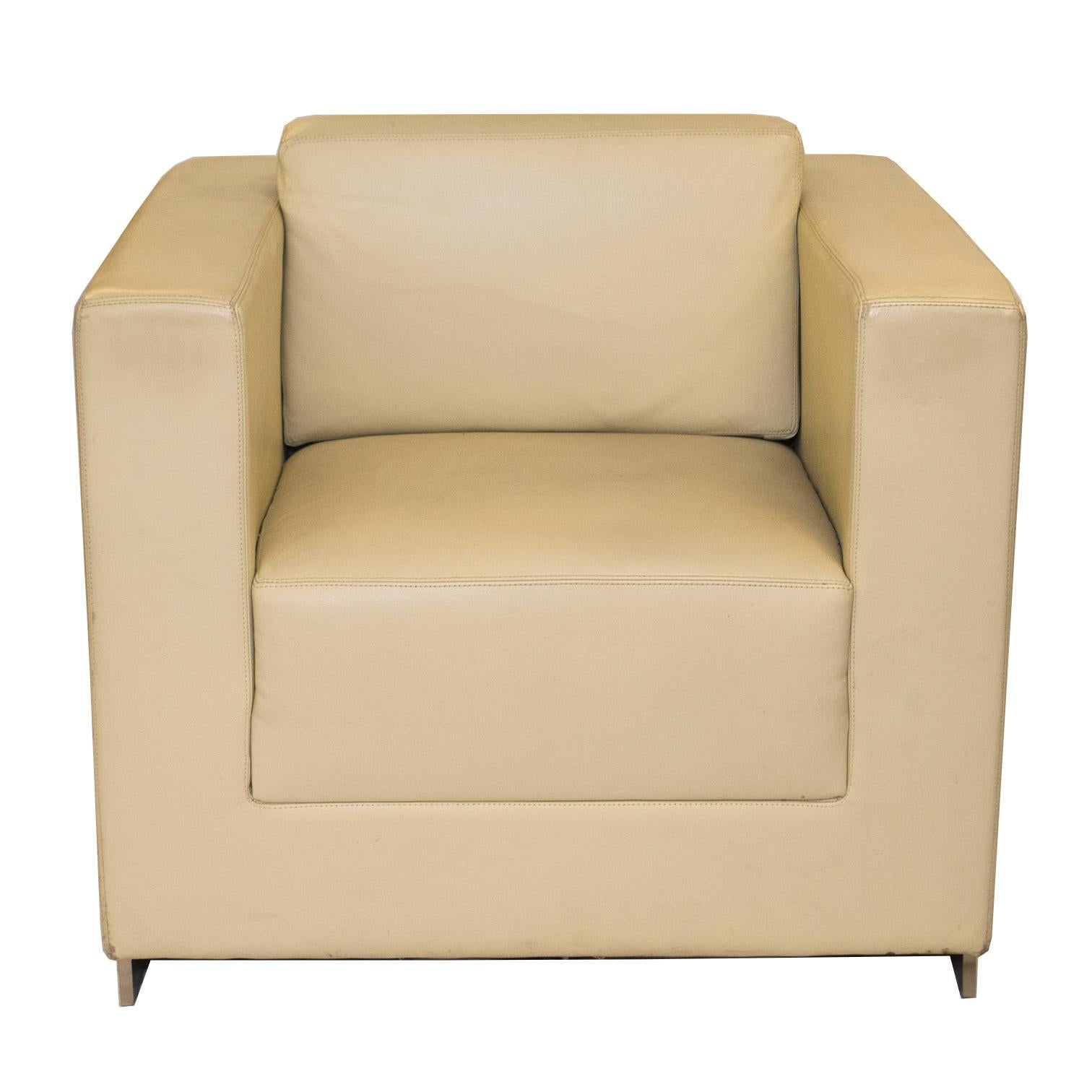 Pair of cube lounge chairs manufactured by Bernhardt Furniture upholstered in a supple creme leather. Clean, simple and structured in design, this pair has a brushed nickel base, saddle stitching, and comfy foam cushioning. Made in North Carolina,
