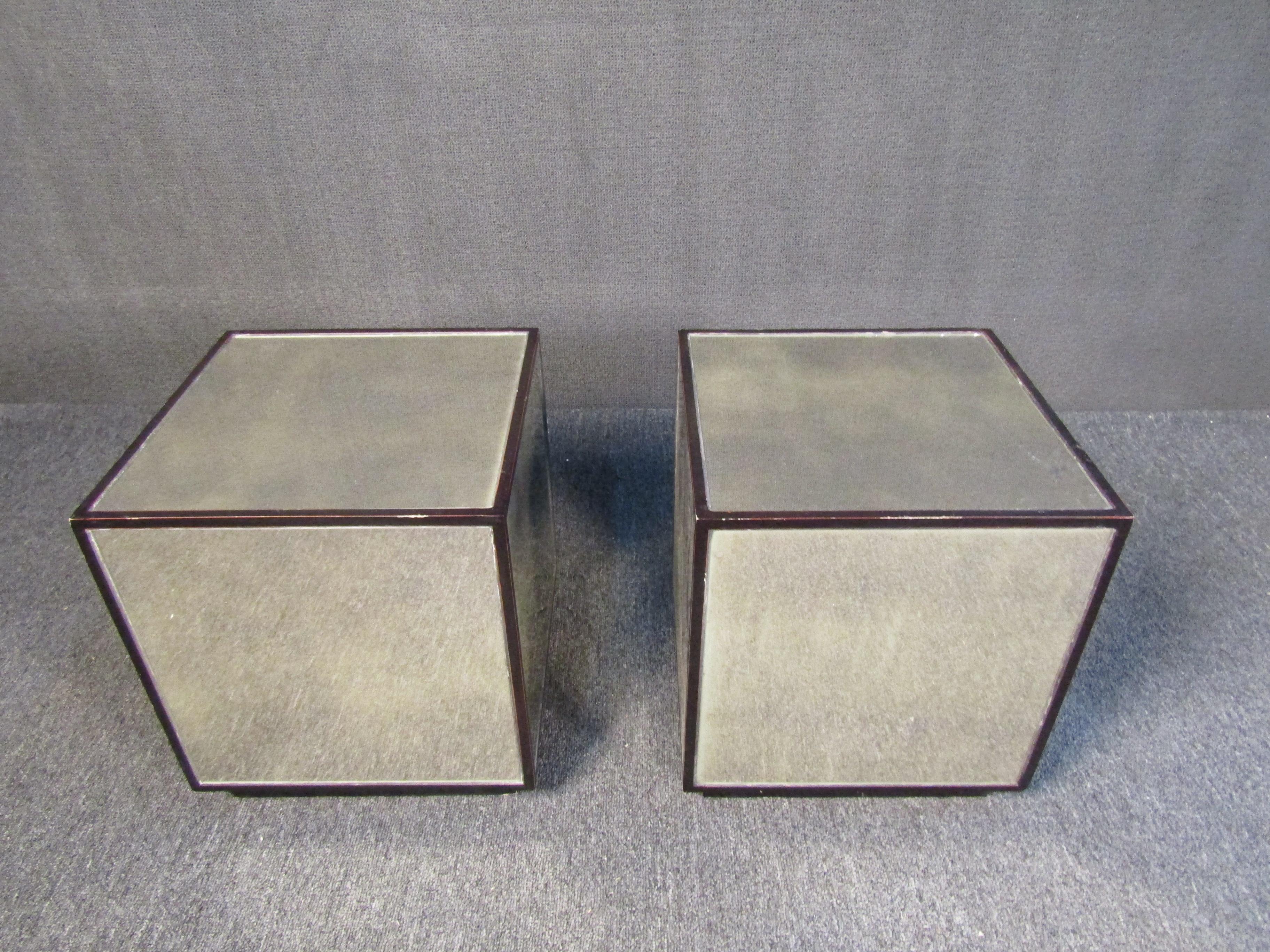 An interesting pair of Mid-Century Modern end tables that are sure to complement their surroundings with their geometric cube shape and mirrored surfaces. Please confirm item location with seller (NY/NJ).