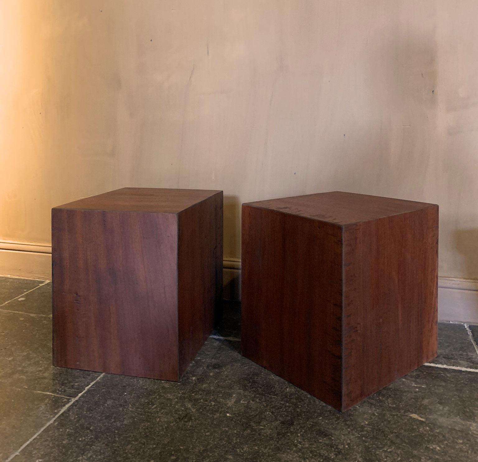 A pair of redwood cubes. We make this multifunctional sidetables from reclaimed one slab boards. The wood is probably a variant of so called bloodwood imported in the 19th century in Europe. We salvaged it in a old Spanish factory were it was used