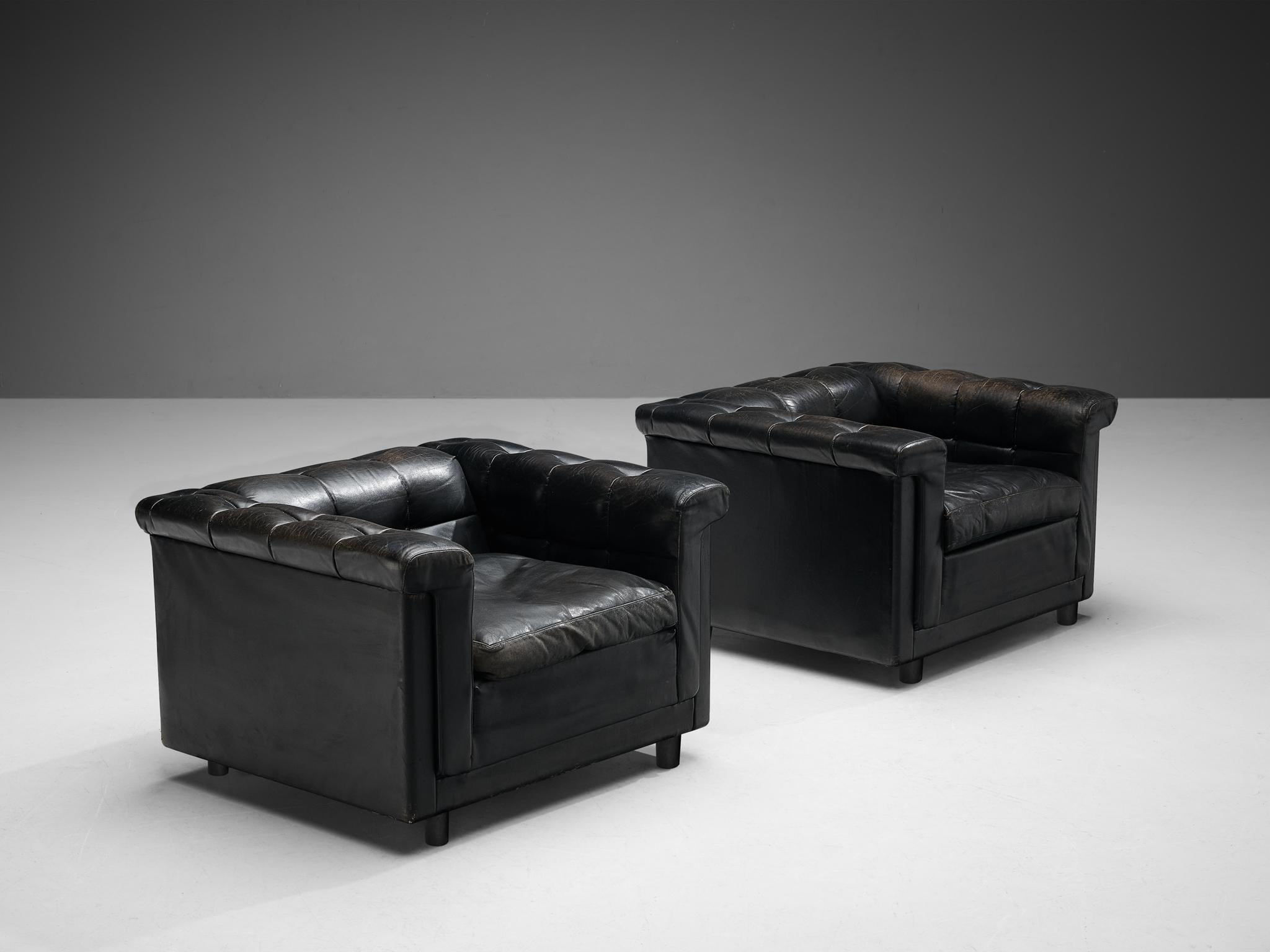 Pair of lounge chairs, black leather, wood, Northern Europe, 1980s

The design of this pair of lounge chairs is characterized by a cubic frame. When seated you experience a pleasant enclosed feeling. The tufted arm and backrests are appealing and