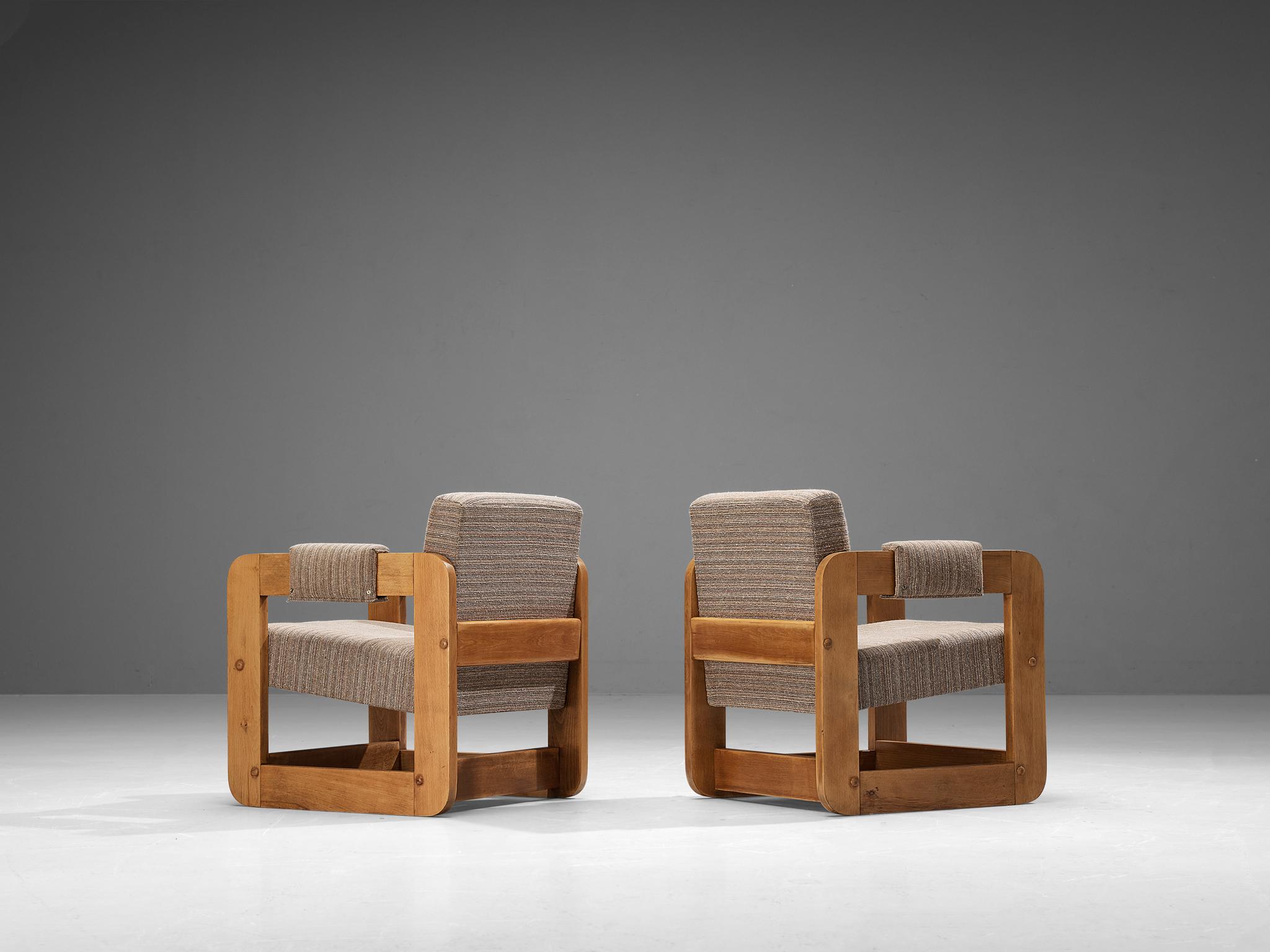 Pair of lounge chairs, beech, fabric, Europe, 1970s. 

Geometric shaped lounge chairs composed of solely cubic forms. The wooden frames that function as armrests are based on a square shape, which gives the unit an open and transparent appeal to