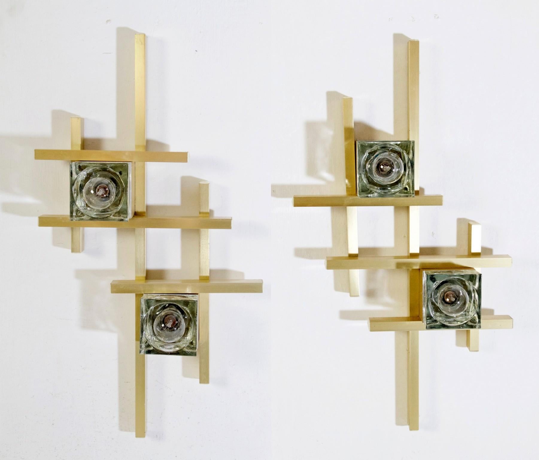 A pair of wall sconces from the Cubic series by Gaetano Sciolari in gold colored metal with two lightbulbs each set in a square of Murano glass.