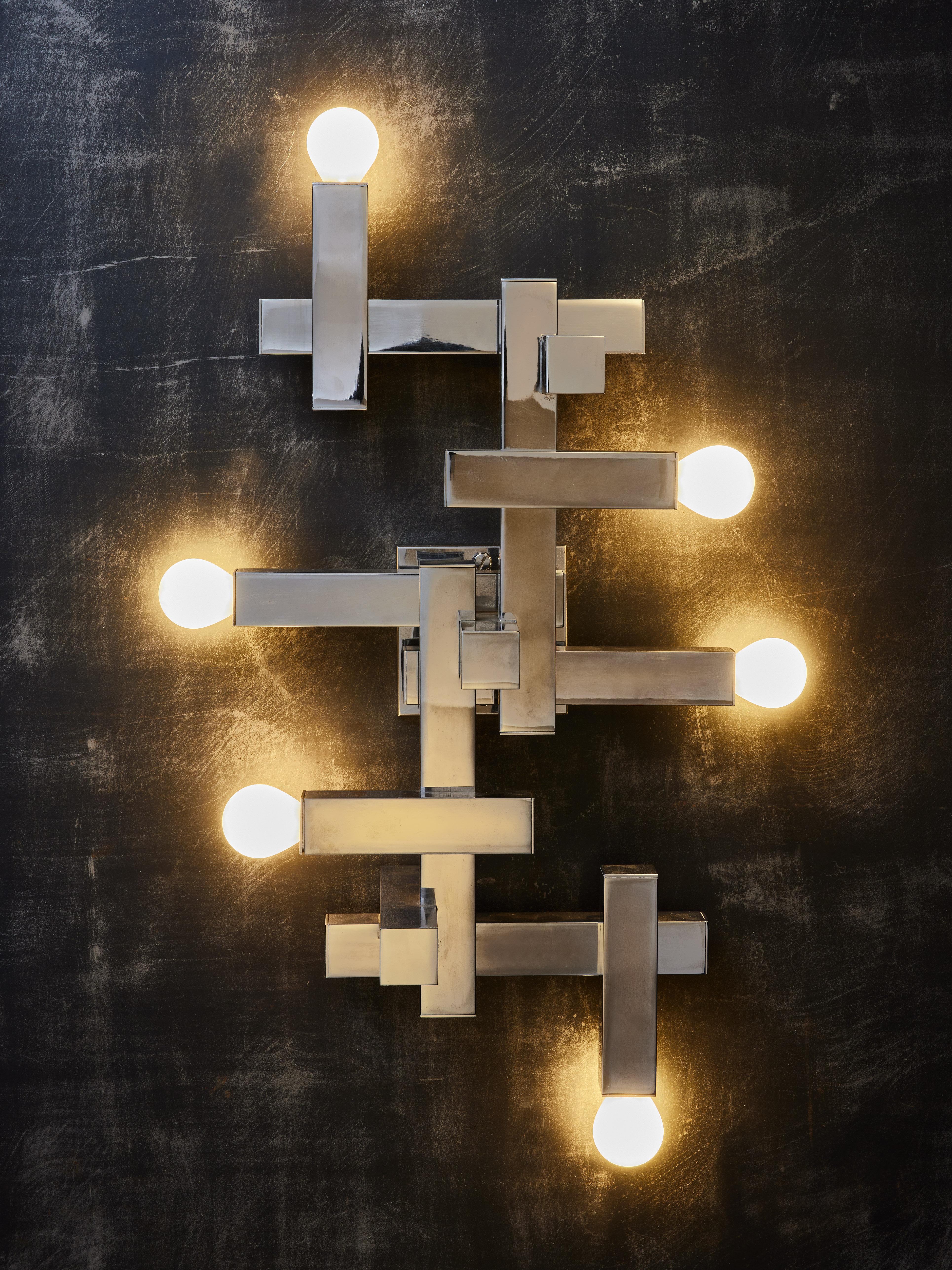 Pair of cubist wall sconces by Gaetano Sciolari made of square tubes geometrically assembled from which come out six sources of light. Can also be attached to the ceiling as a flush mount. Original maker sticker at the back.