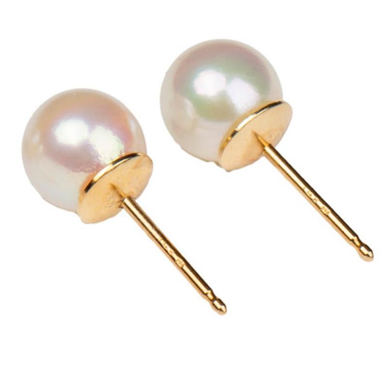 Beautiful pair of classic cultured pearl earrings, each pearl of high luster and even creamy-white color. The round pearls measure 7.0 mm, attached to 14 karat yellow gold posts for stud earrings.

21st century, new

Excellent condition