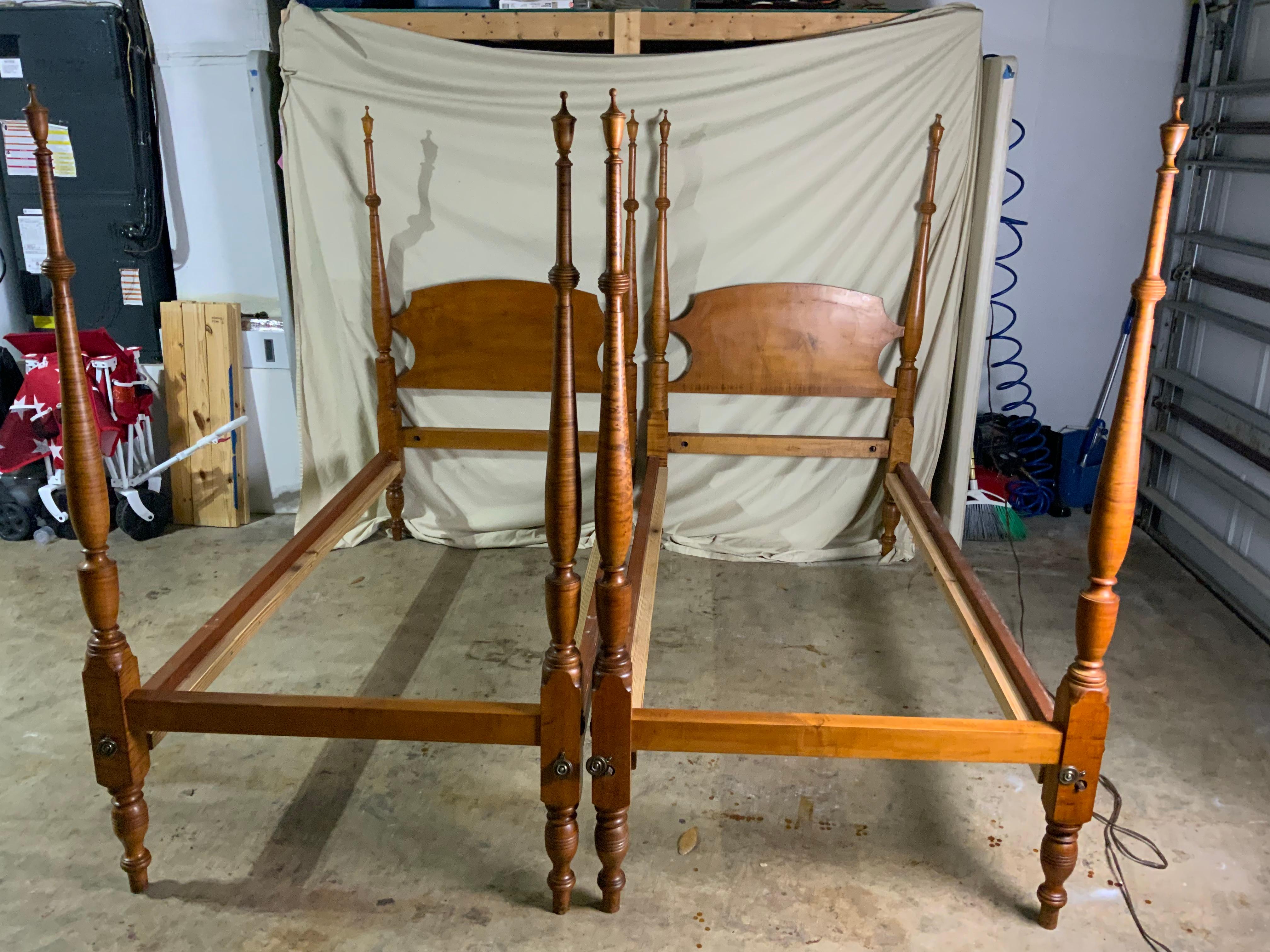 A beautiful pair of centennial era Curly and Birdseye Maple twin poster beds. The bed rails are held together with bed bolts and the frames fit a standard twin size mattress. Highly figured Maple on the nicely turned posts with removable finials for