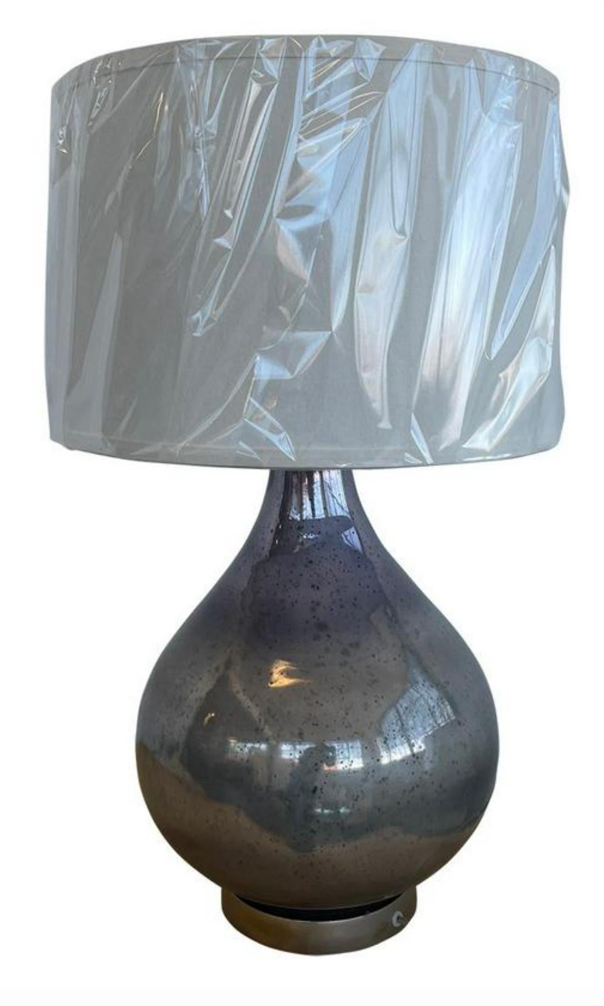 Pair of substantial patinated mercury glass table lamps designed by world renown Interior Design team of Currey & Company. Titled “Nightsea”, as the finish of the large gourd form lamp bodies reminds one of a “turbulent night sea”. Out of production