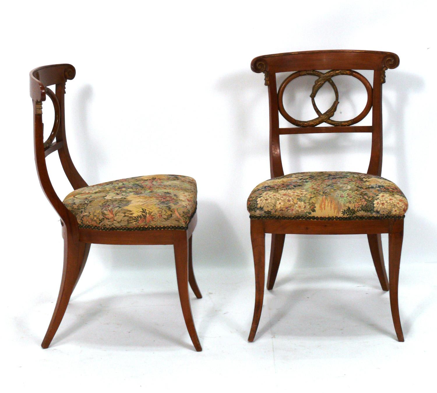 Pair of Curvaceous Italian Chairs with Gilt Ouroboros Decoration, believed to be late 19th or early 20th Century, Italian. These chairs are currently being reupholstered and can be completed in your fabric. Simply send us 1.5 yards of your fabric