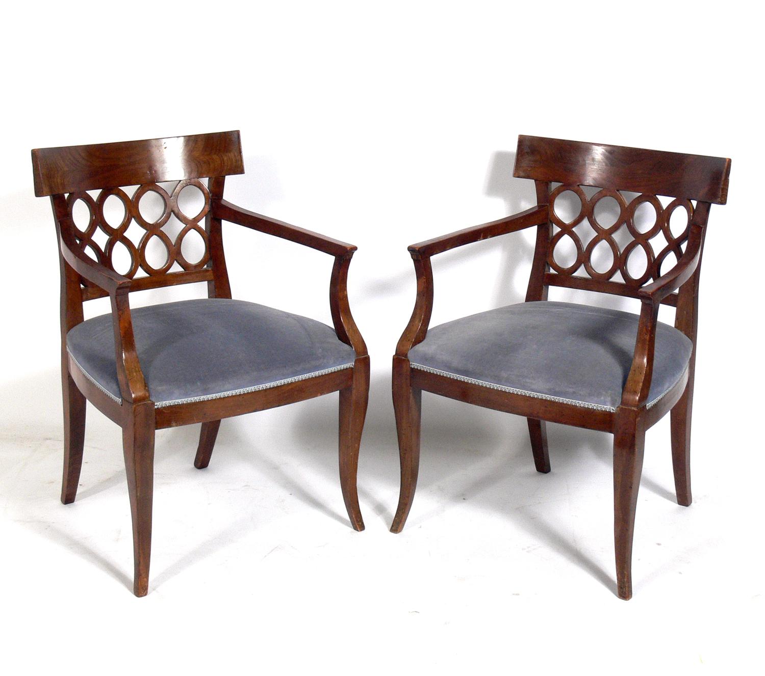 Pair of curvaceous Italian fret back chairs, Italy, circa 1950s. The seats are currently being reupholstered and can be completed in your fabric at no additional charge. The price noted below includes reupholstery in your fabric.