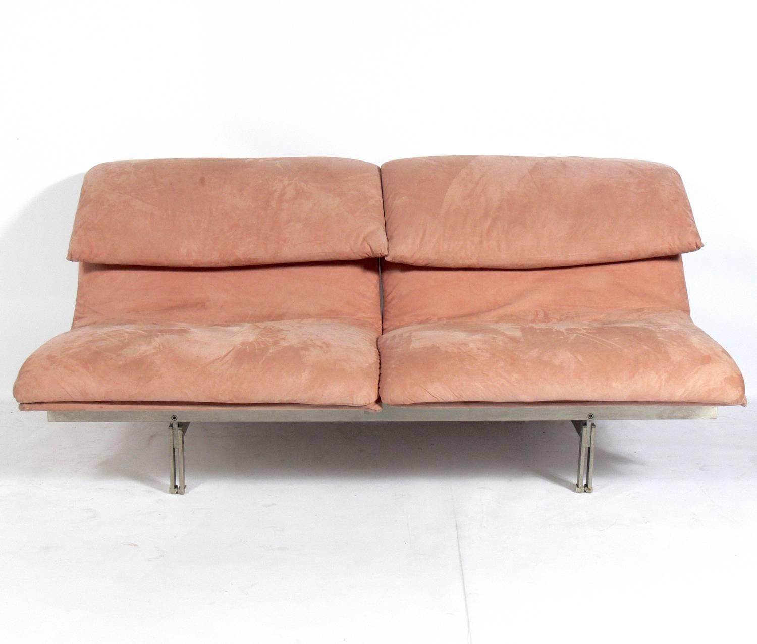 Pair of curvaceous Italian sofas or settees by Saporiti, Italy, circa 1980s. They seat two to four people each, depending on the size and friendliness of those seated. The dusky pink suede upholstery probably needs to be replaced unless you really