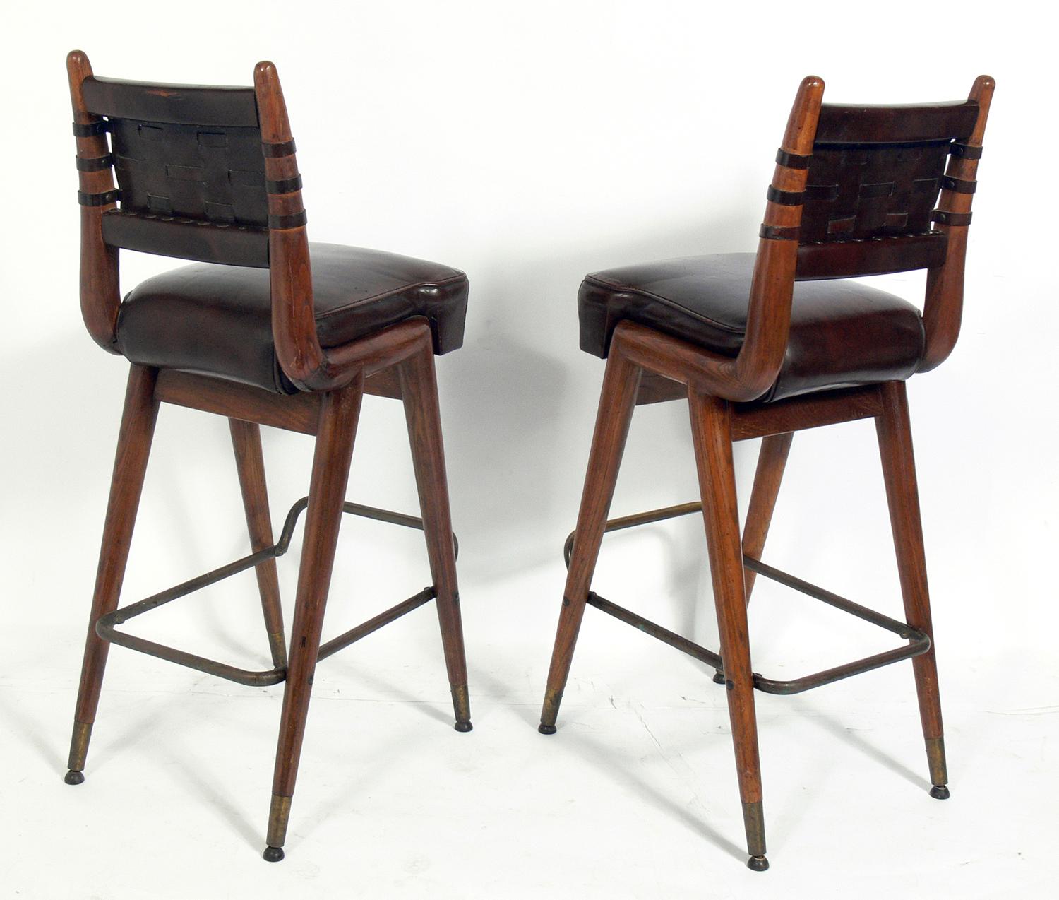 American Pair of Curvaceous Oak Leather and Brass Bar Stools