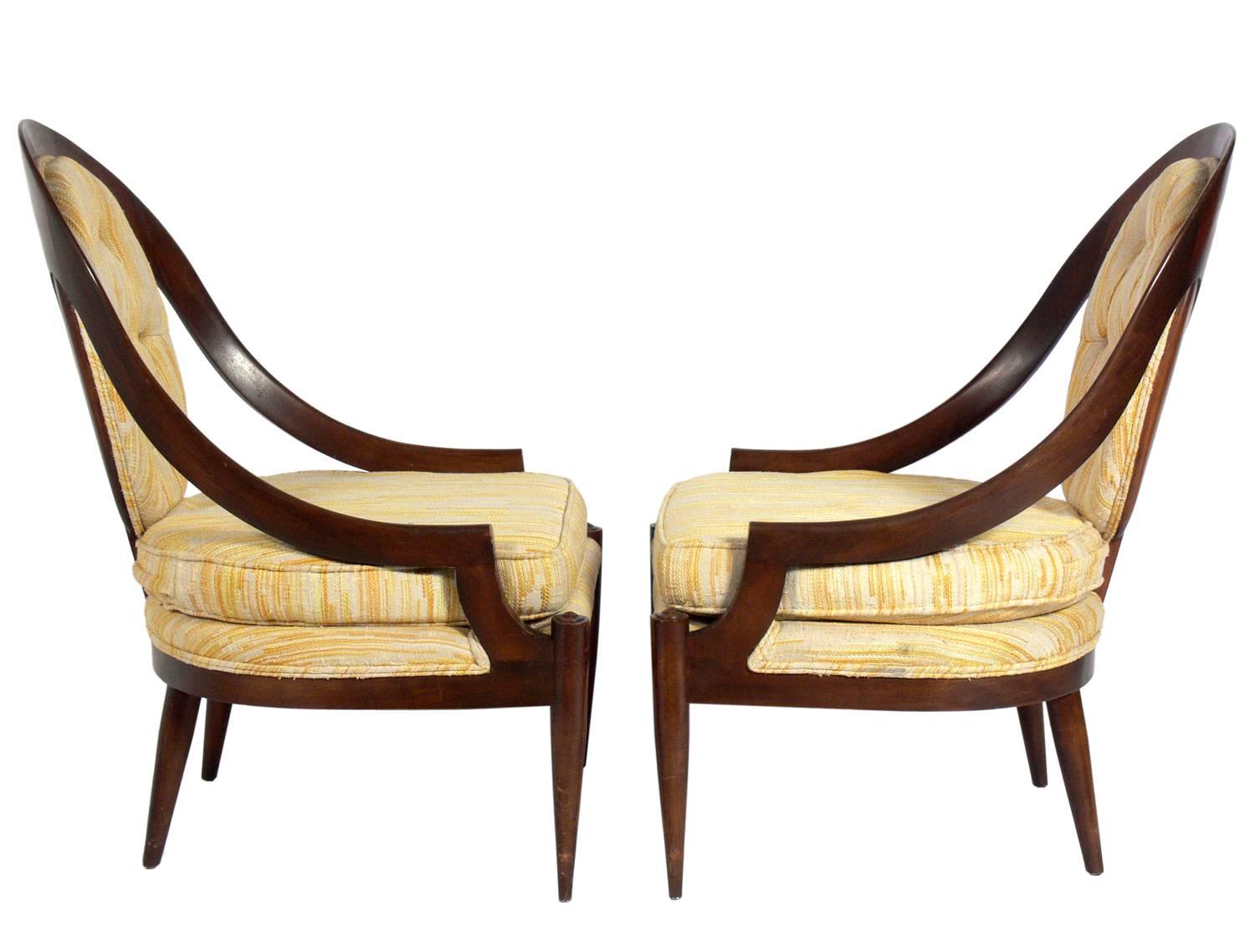 Pair of curvaceous spoonback lounge chairs, American, circa 1950s. They will need to be reupholstered. The price noted below includes reupholster in your fabric.