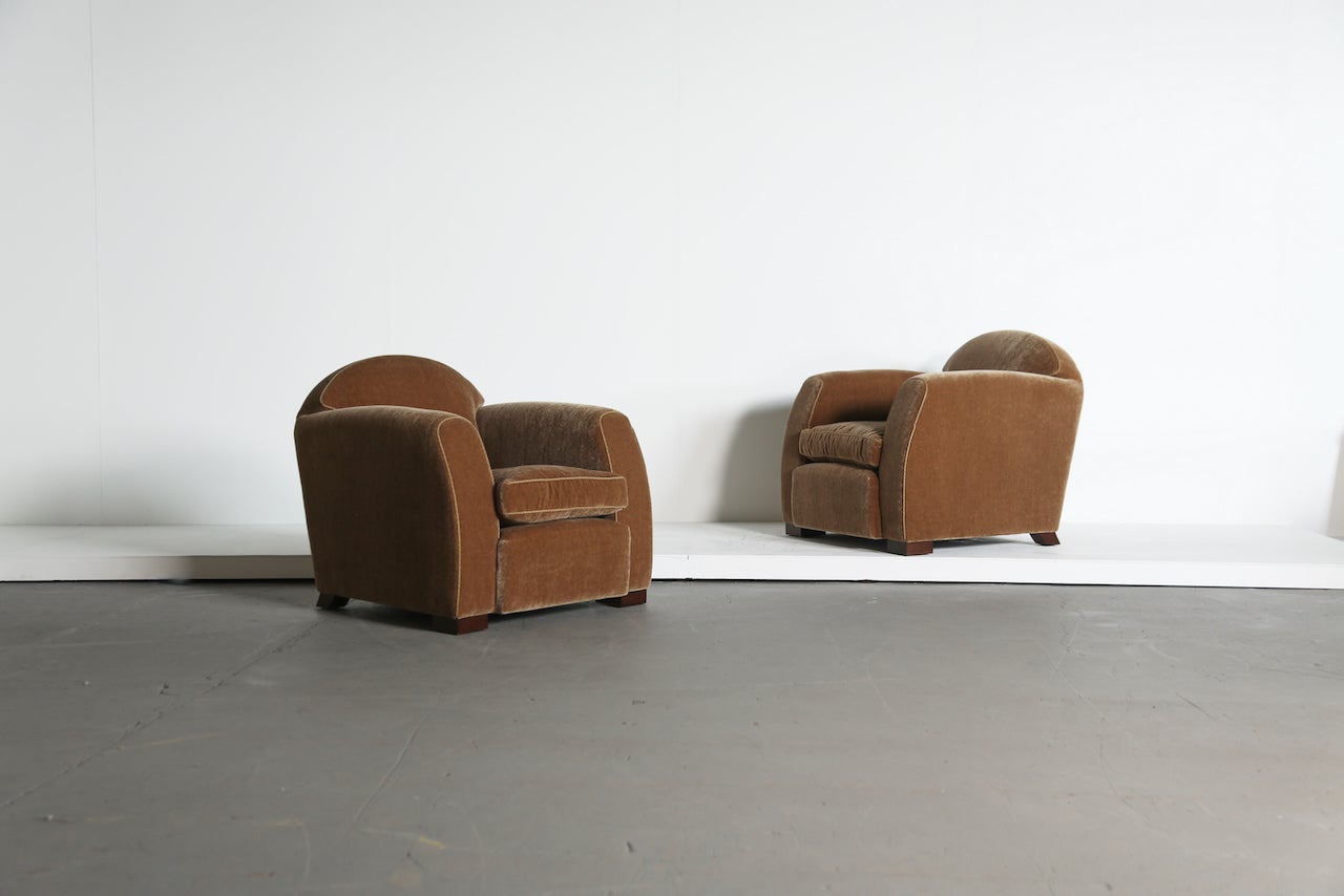 An elegant, luxurious and comfortable pair of modern curved arm club chairs / armchairs.  Beech frames, feather cushions and sprung seats.  Newly upholstered in a premium golden brown, soft, pure mohair fabric.  Handmade in England.  Also available