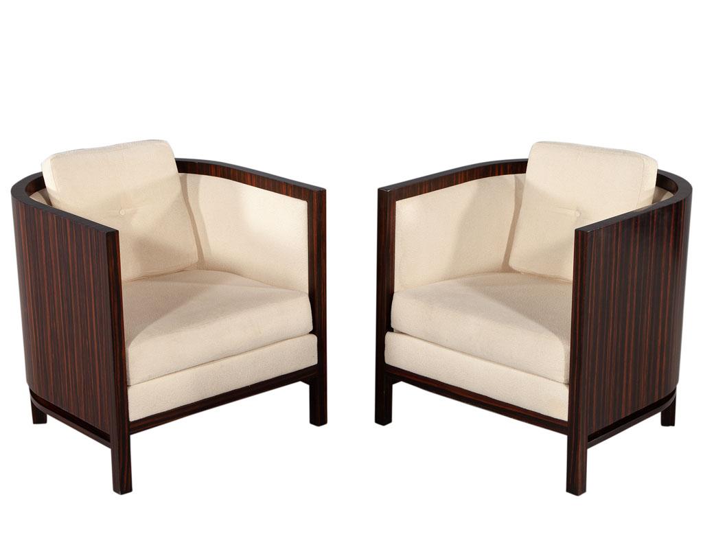These beautiful art deco lounge chairs are sure to make a statement in any room. Crafted from macassar wood, they are finished in a sophisticated satin macassar color to bring out the luxurious macassar wood grains. Upholstered in a textured