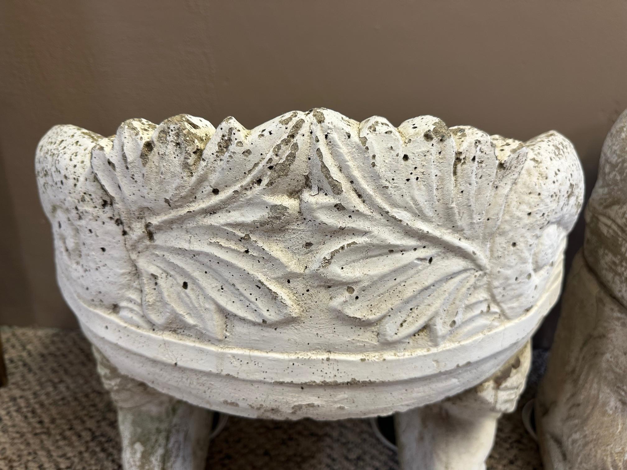 
Pair of rare fascinatingly shaped concrete garden seats having rounded backs with leaf decoration and carved animal motif bases.
