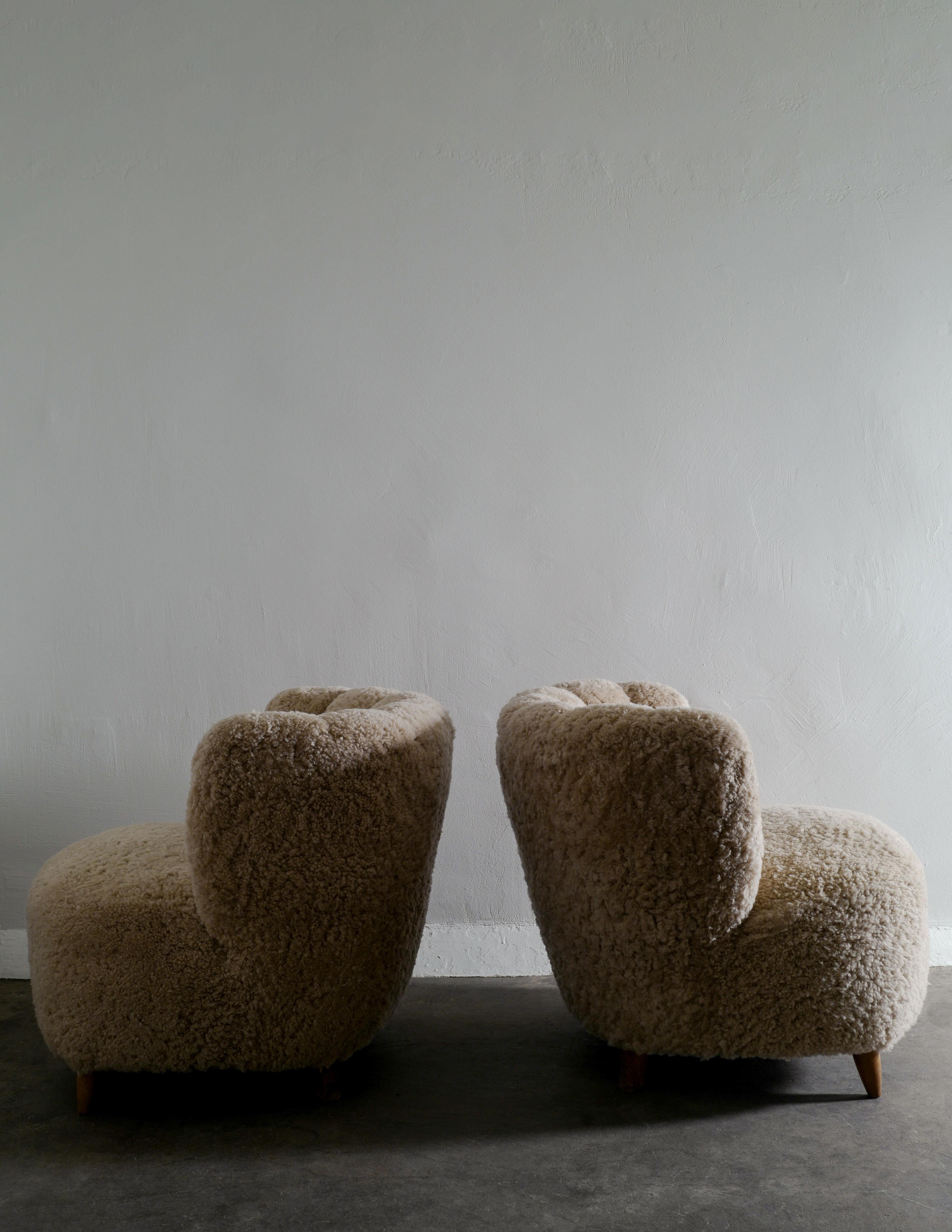 Scandinavian Modern Pair of Curved Danish Easy Lounge Chairs in Sheepskin Produced in Denmark 1940s