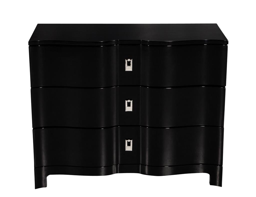 Introducing a stunning addition to your home decor - a pair of modern curved front black lacquered chests. These chests feature sculpted curved fronts that add a touch of elegance and sophistication to any room. The polished high gloss black lacquer