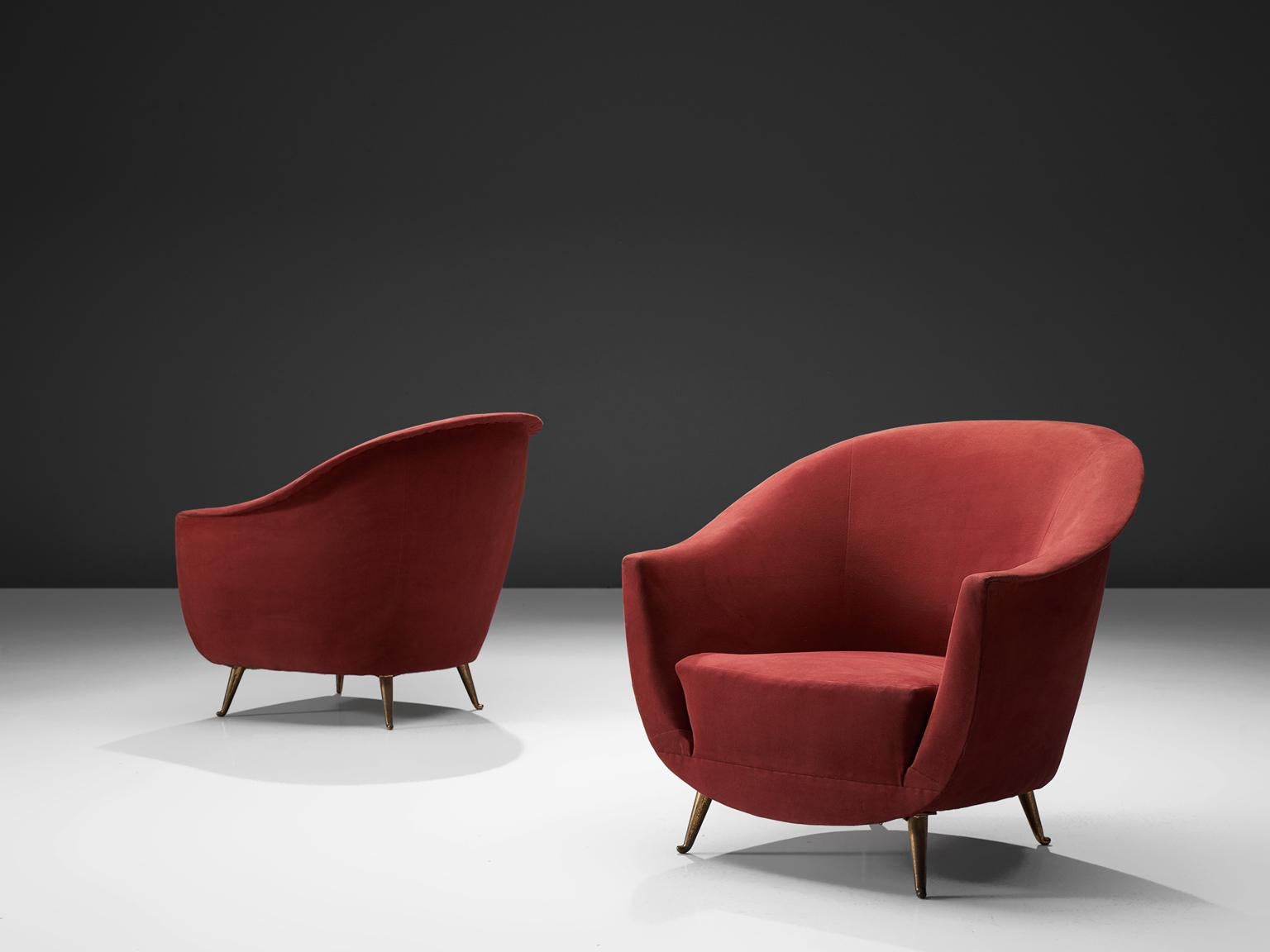 Lounge chairs, red fabric, wood, Italy, 1950s.

These red chairs in the style of Guglielmo Veronesi feature a high back with high armrests that are almost as high as the back. As a result, this chair works as a type of shell that embraces the