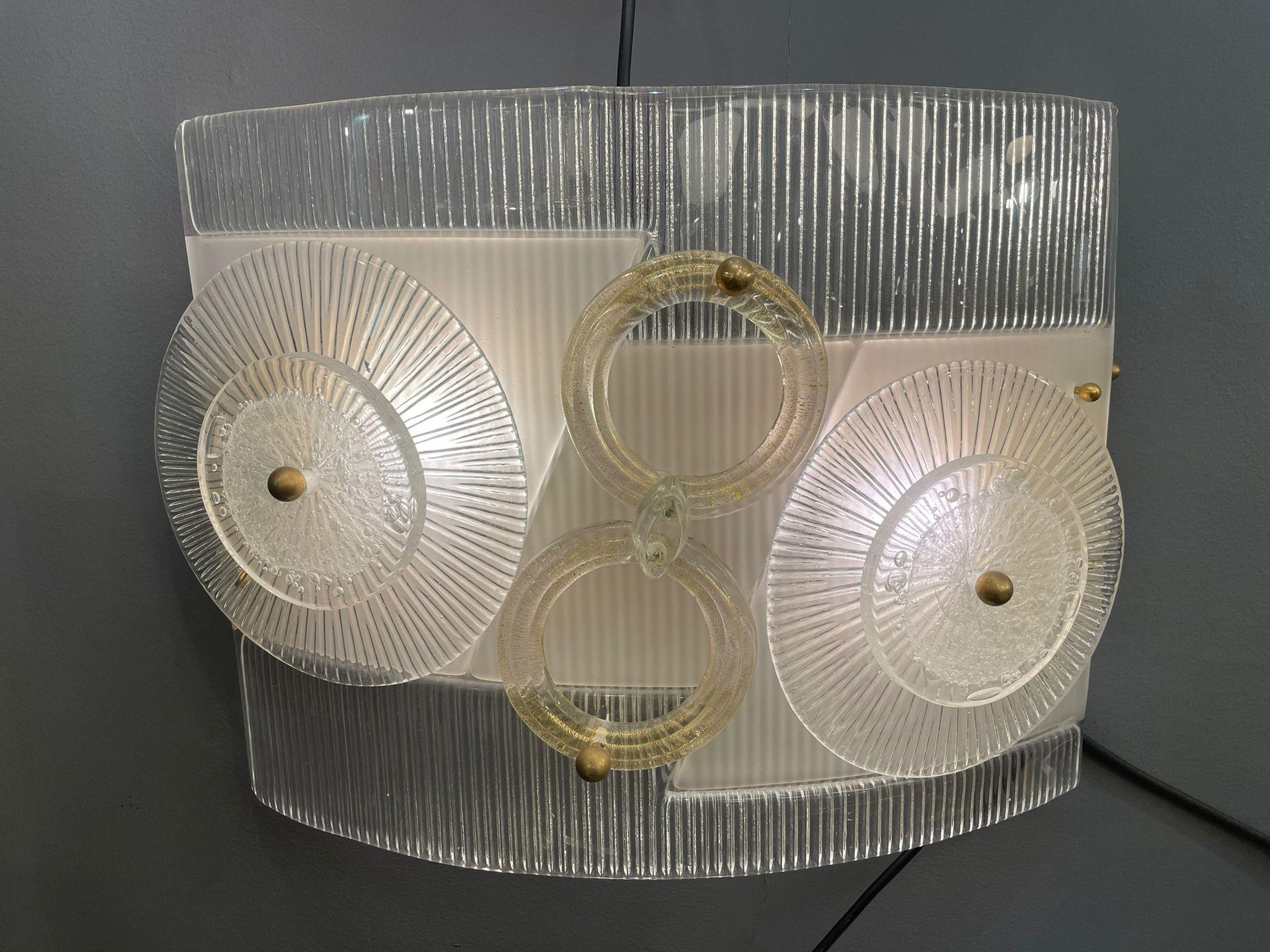 A fantastic pair of curved Murano glass wall lights with round white and light amber murano glass decorations. Italy 1960s.