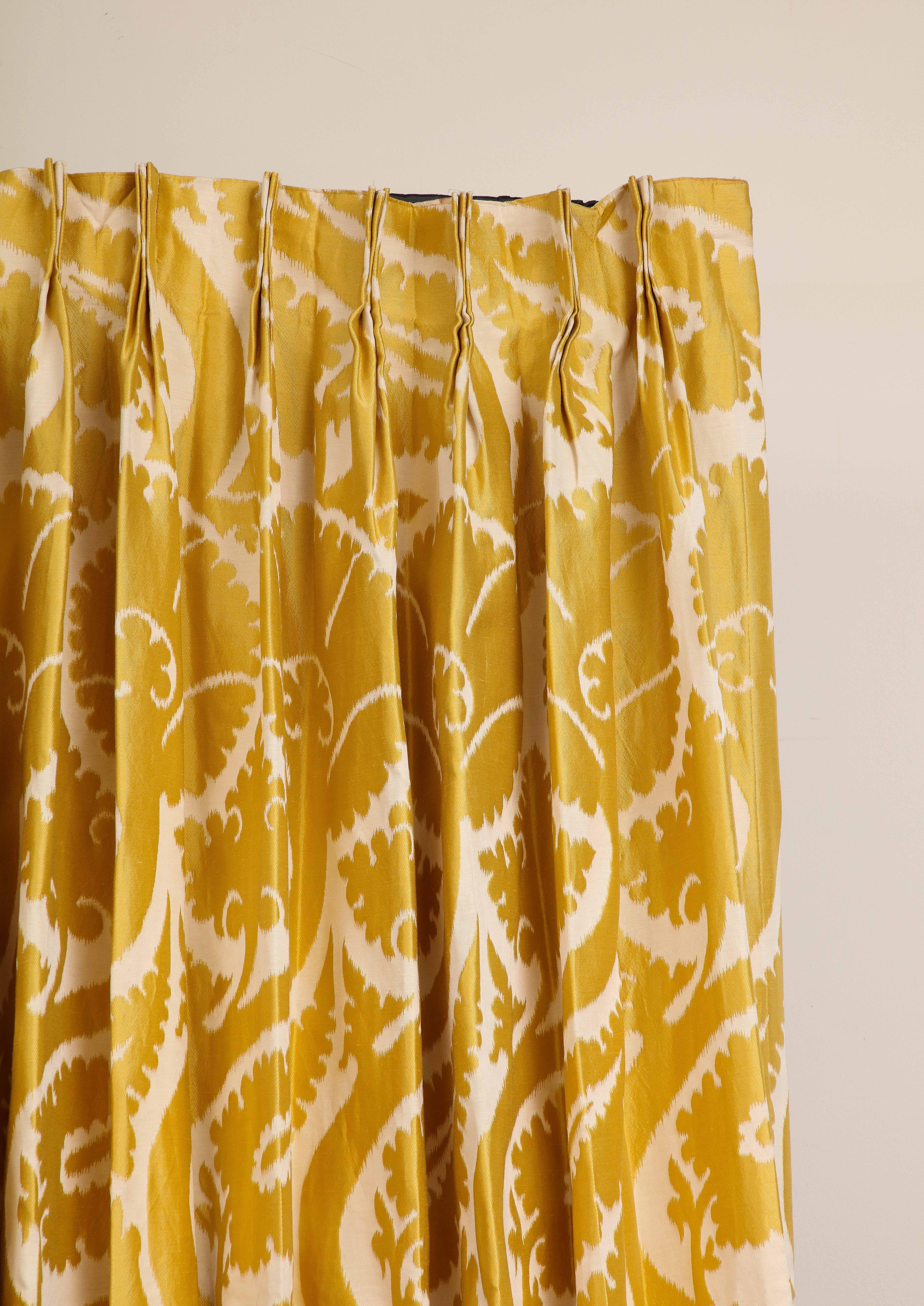 A pair (2 panels) of custom privacy-lined drapes in Pierre Frey Sidonia Girasole 2 golden yellow fabric. The fabric has since been discontinued. The panels feature pinch pleats with a 5