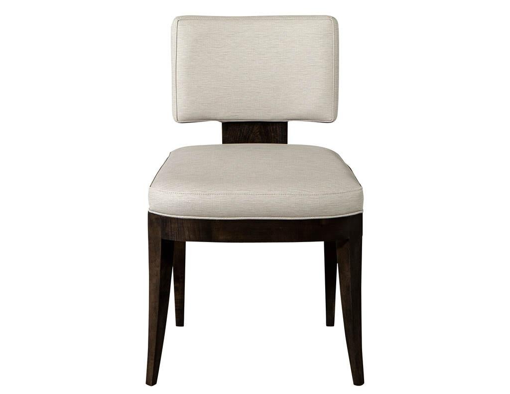 Pair of custom contemporary side chairs. Neo-deco curved back design, custom made by the artisans at Carrocel. Solid maple frame finished in a rich espresso color. Upholstered in a pale beige vinyl fabric. Chairs can be custom ordered in larger