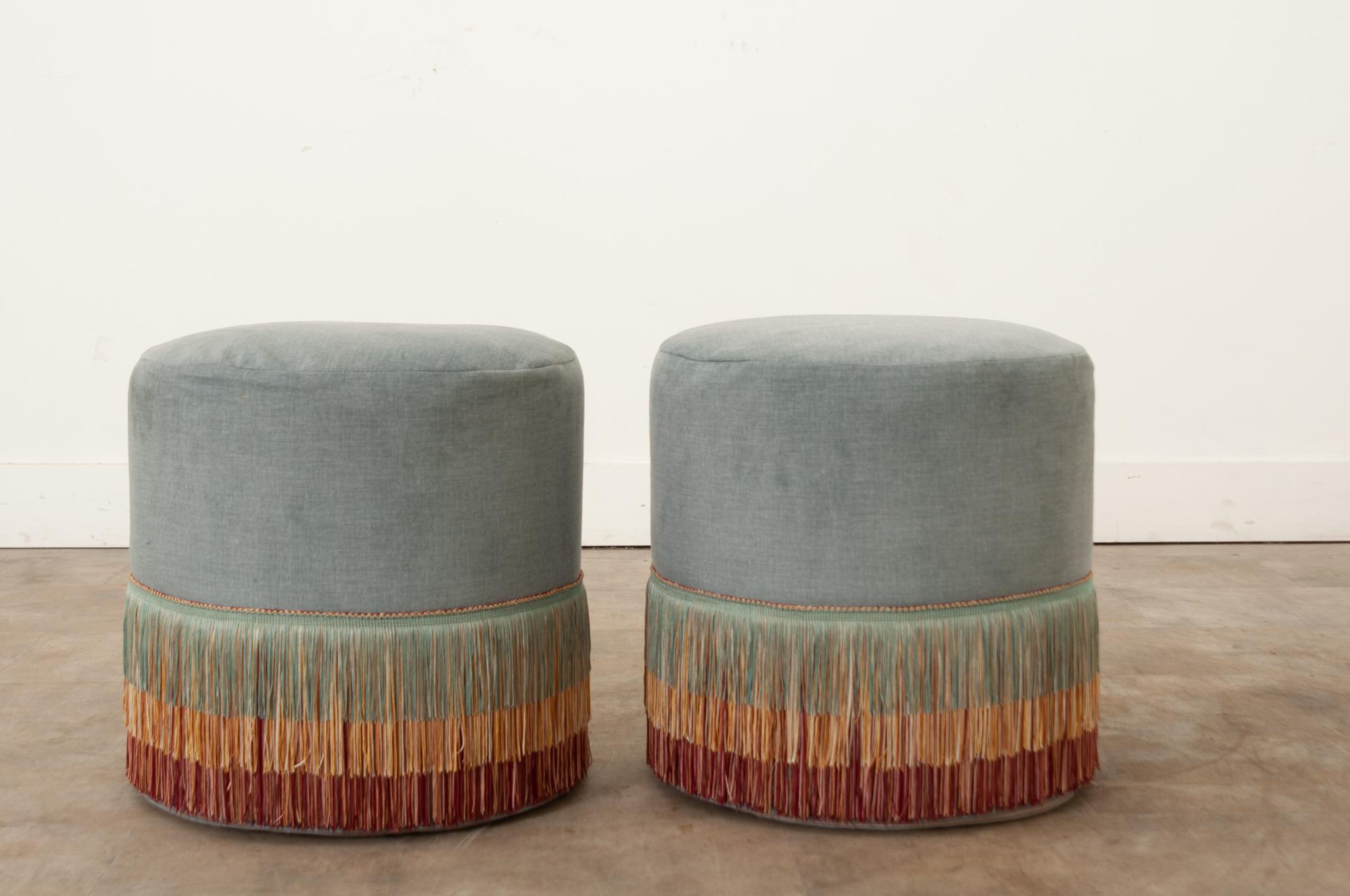 A pair of recently made custom ottomans made with a soft light blue velvet and tiered fringe. Comfortable and stylish, this pair of ottomans are playful and functional. Be sure to view the detailed images to see the current condition.