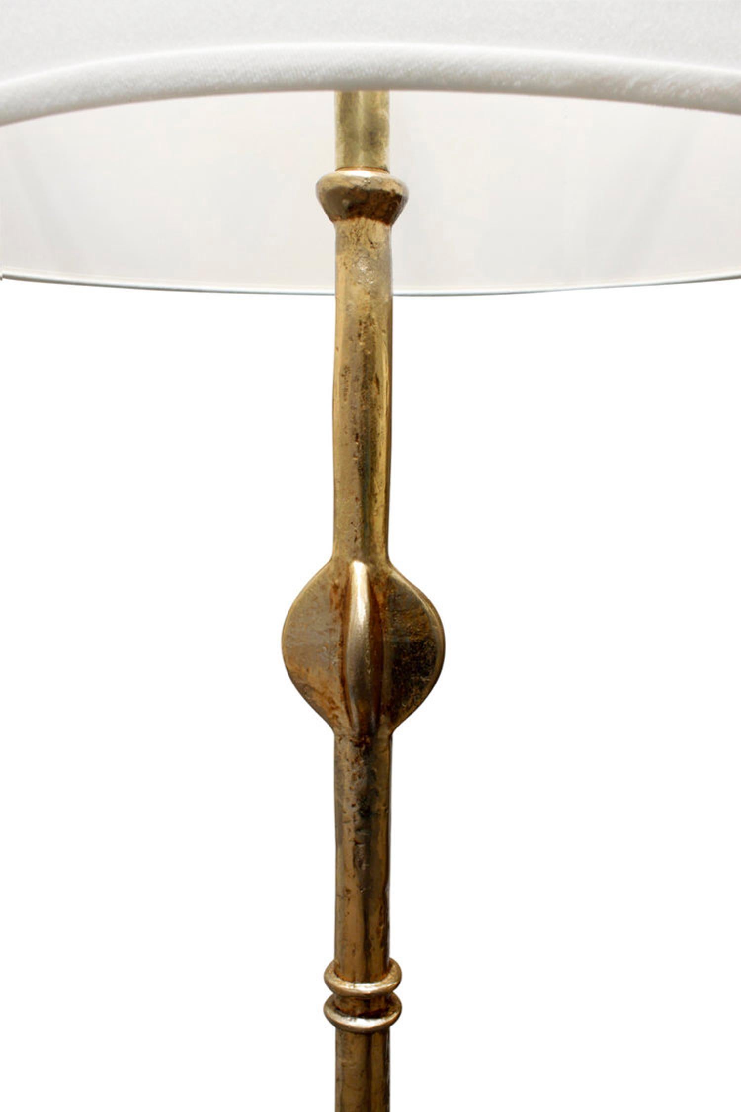 Pair of beautifully crafted gilded Giacometti style floor lamps, custom design, American 1970's. These are both hand-forged and extremely elegant.

Shade shown is 19.5 inches in diameter.