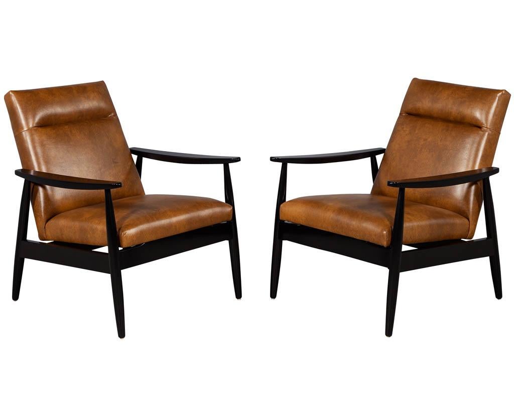 Pair of custom leather accent chairs by Carrocel. These Mid-Century Modern inspired chairs are finished in an ebonized hand rubbed black lacquer and upholstered in an Italian tobacco hand finished butter soft leather.

Price includes complimentary