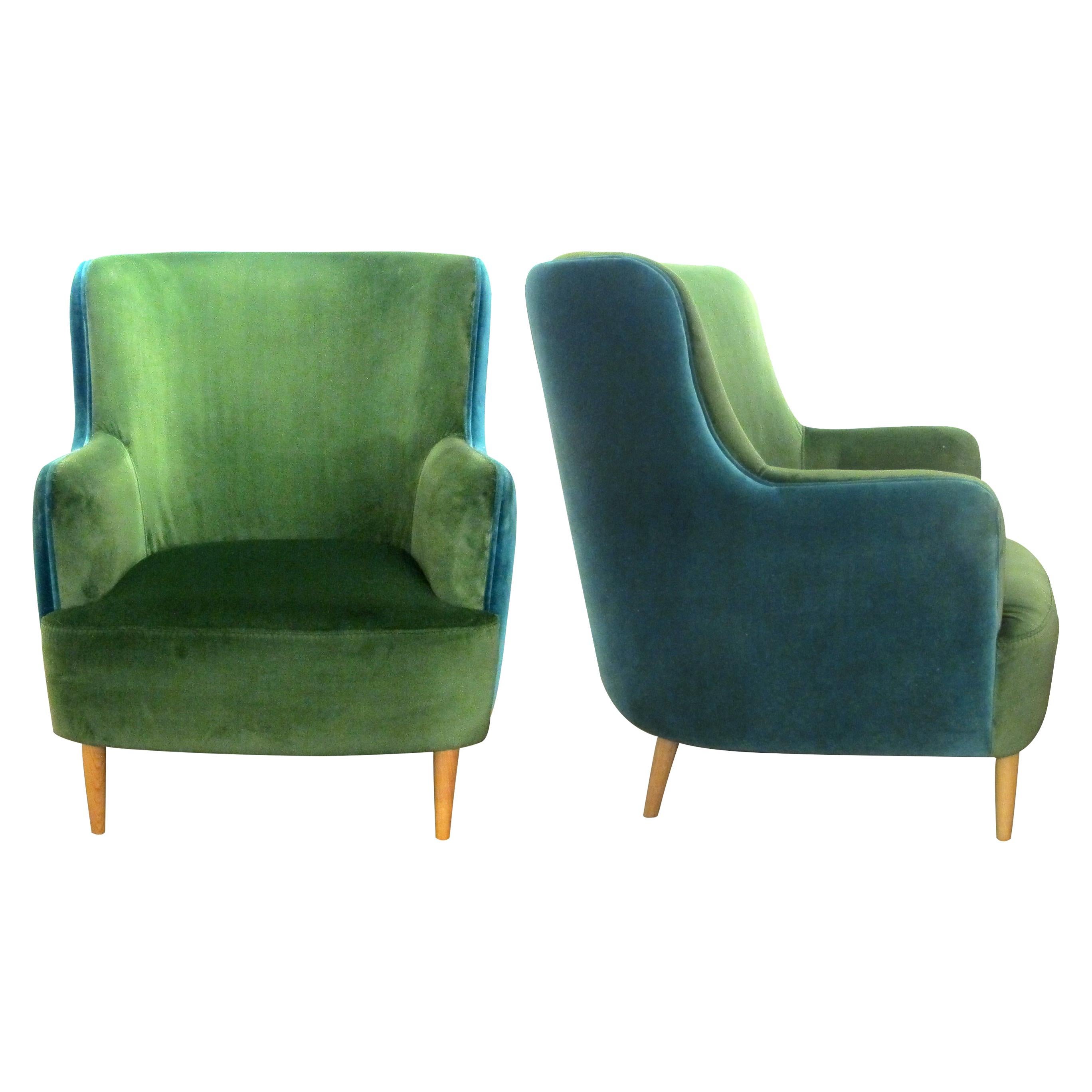 A beautiful pair of custom-made, two-tone, deep-seated and high-backed lounge or armchairs which have been reupholstered in a contrasting green fabric on the arms, seat and and front with the same fabric but in turquoise on the back. The