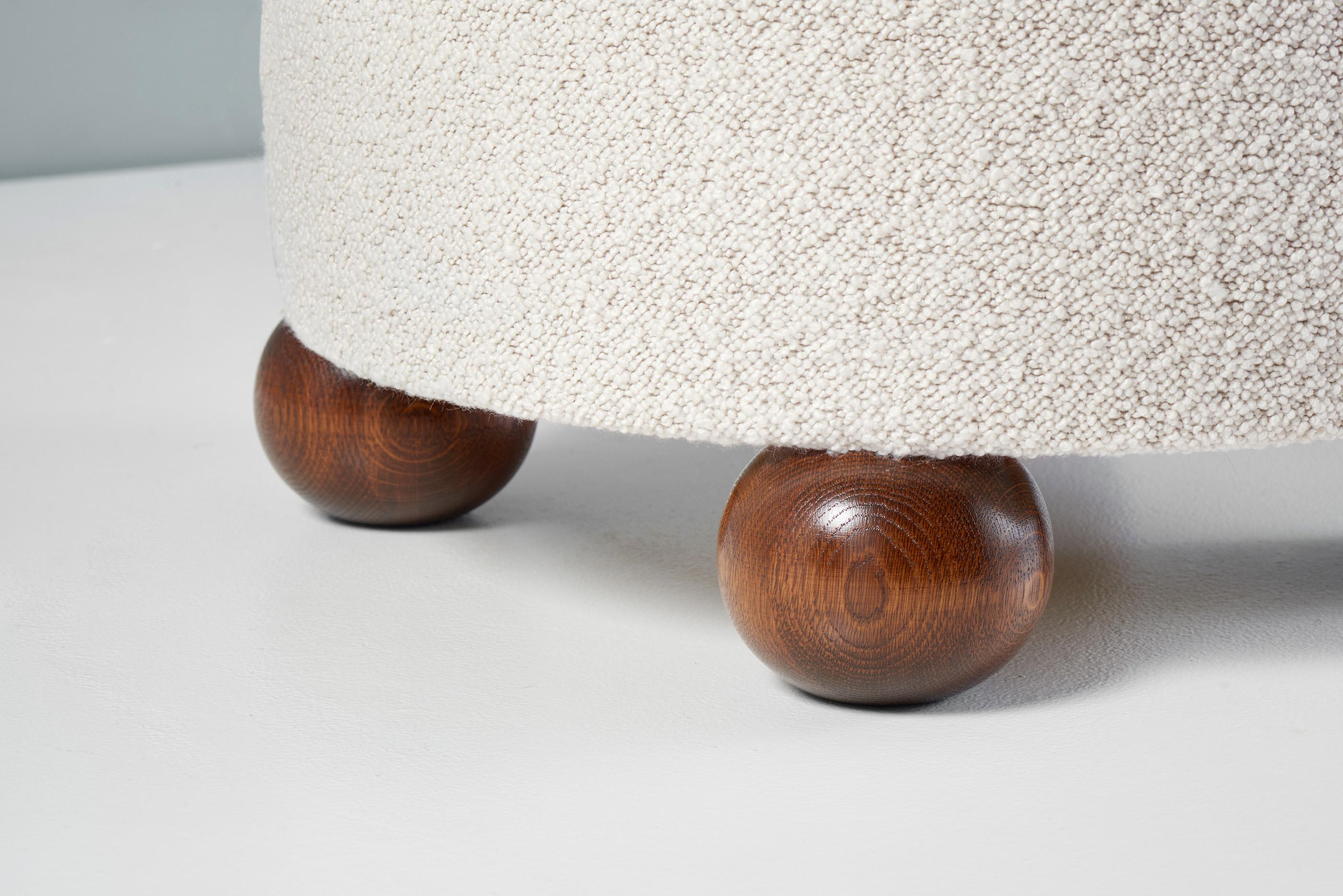 British Pair of Custom Made Round Boucle Ottomans with Oak Ball Feet. Available in COM For Sale