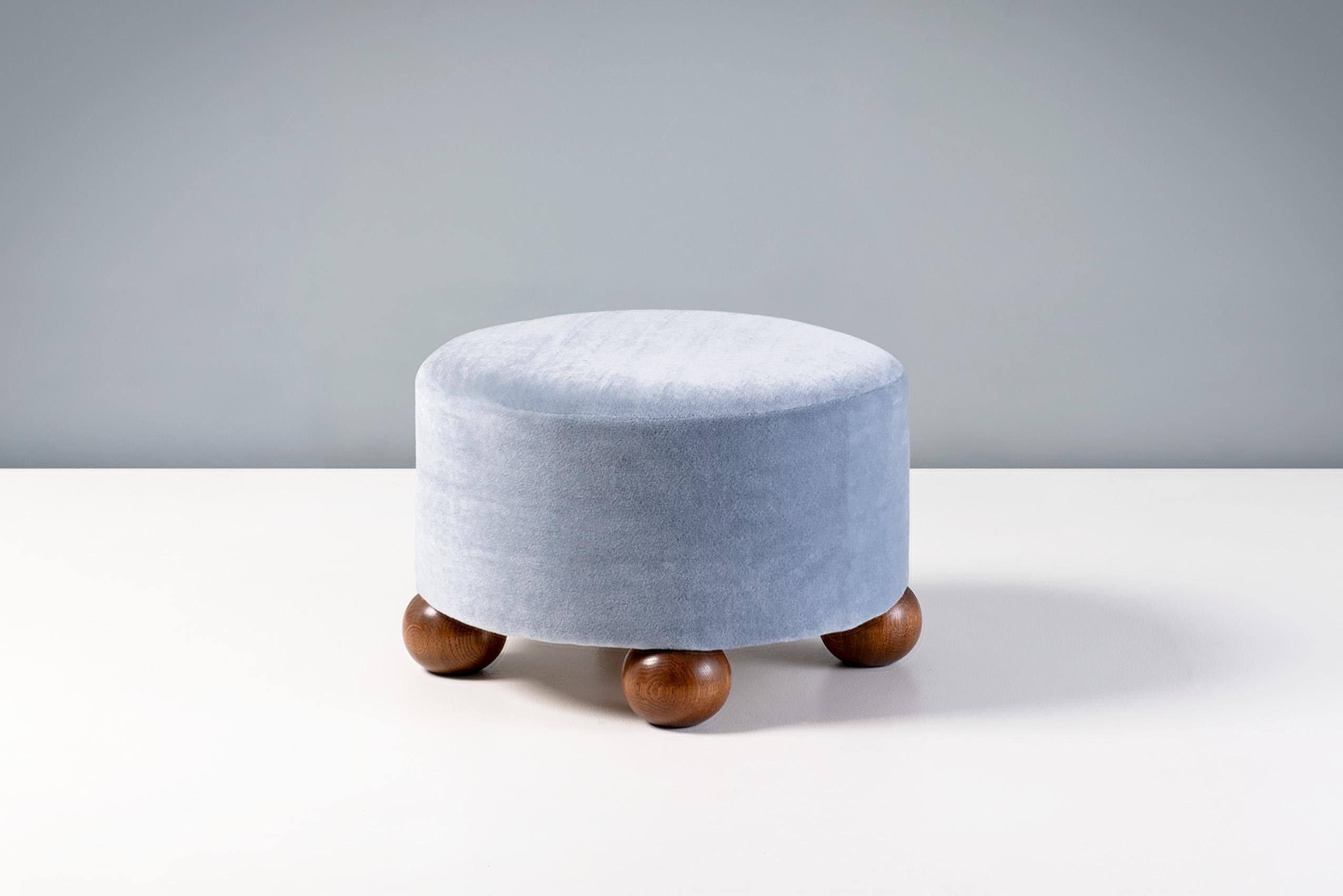 Dagmar - Luupo Round Ottoman

Custom-made ottoman developed & produced at our workshops in London using the highest quality materials. This example is upholstered in a sky blue mohair velvet by Pierre Frey with fumed oak ball feet. This ottoman is