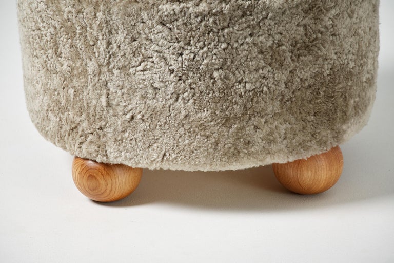 Scandinavian Modern Pair of Custom Made Round Sheepskin Ottomans with Oak Ball Feet For Sale