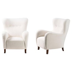 Pair of custom Made Sampo Boucle Wing Chairs