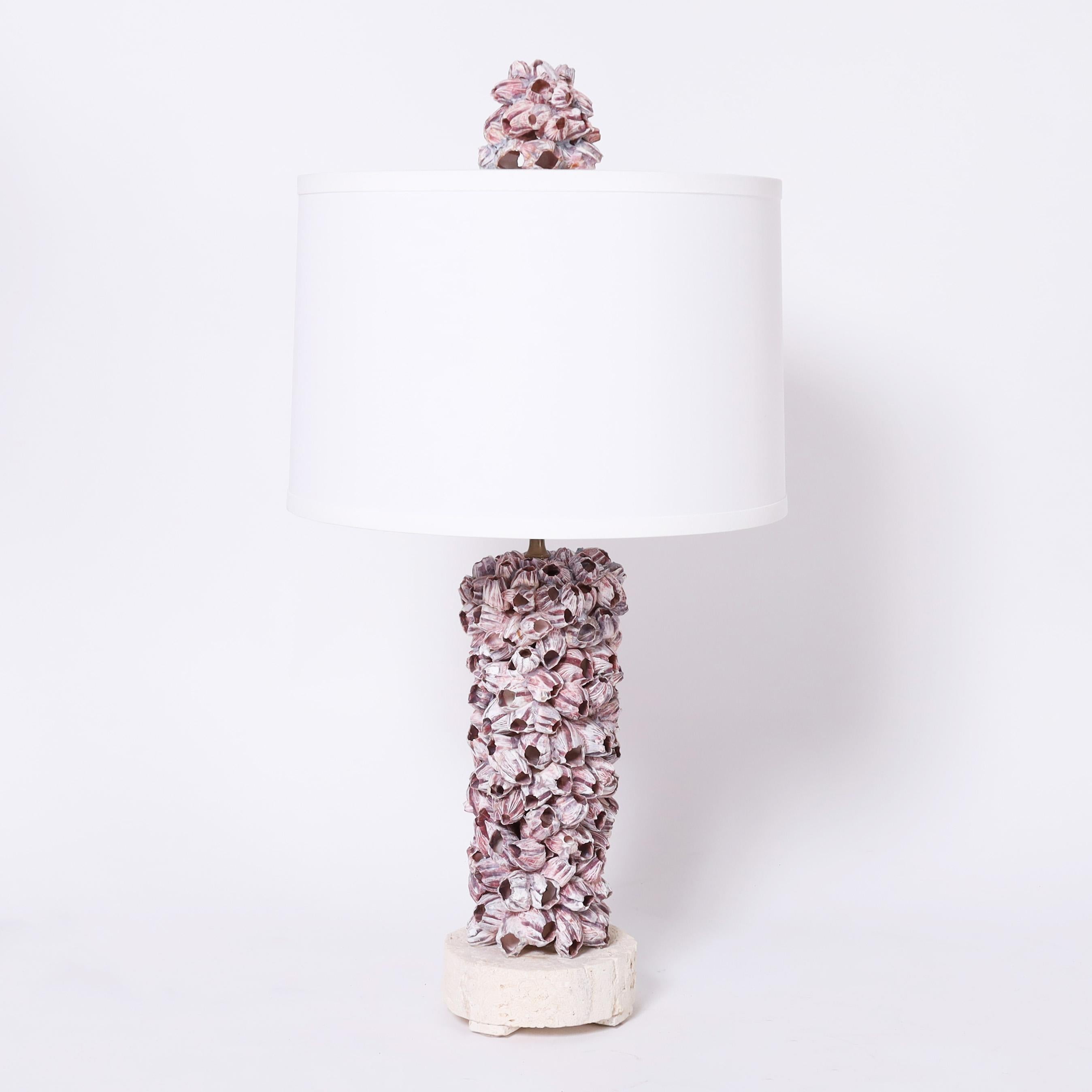 Striking pair of modern table lamps and matching finials exclusively designed and handcrafted by FS Henemader Antiques with organic barnacle specimens, presented on coquina bases.