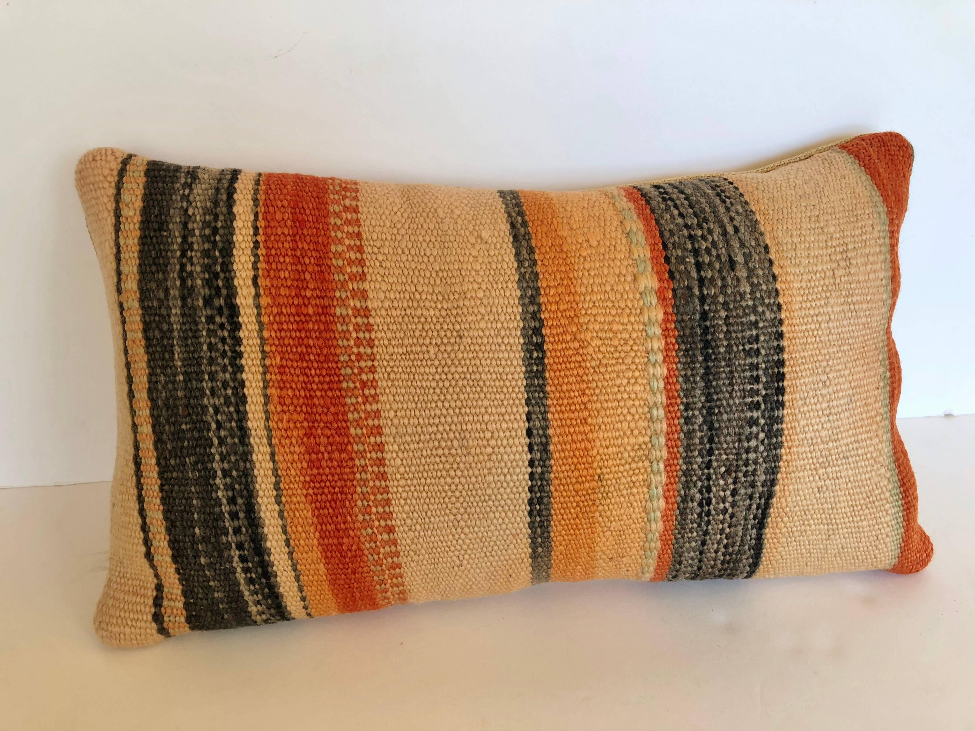 Custom pillows cut from a vintage hand loomed wool Moroccan Berber rug from the Atlas Mountains. Wool is soft and lustrous with all natural colors. Pillows are backed in linen, filled with an insert of 50/50 down and feathers and hand sewn closed.