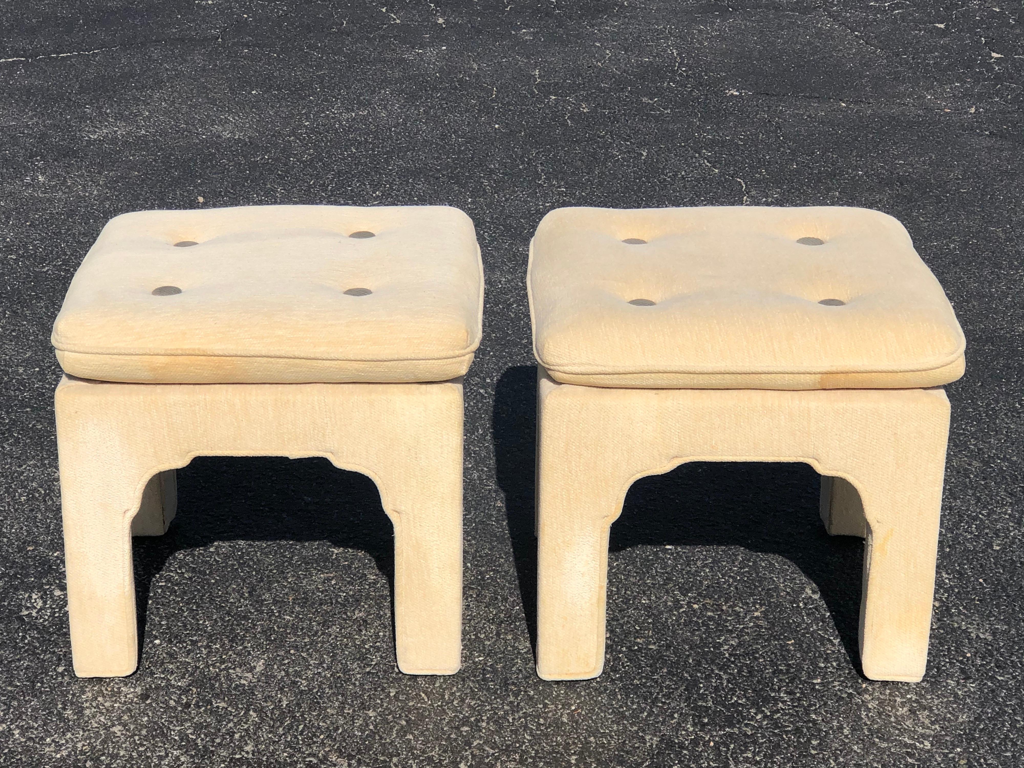 Pair of custom pillow top upholstered ottomans. Covered in a cream chennile with an olive green upholstered button. Nice two tone effect. Perfect for under a console table or at thte foot of a bed. These can parcel ship for $69 domestically.